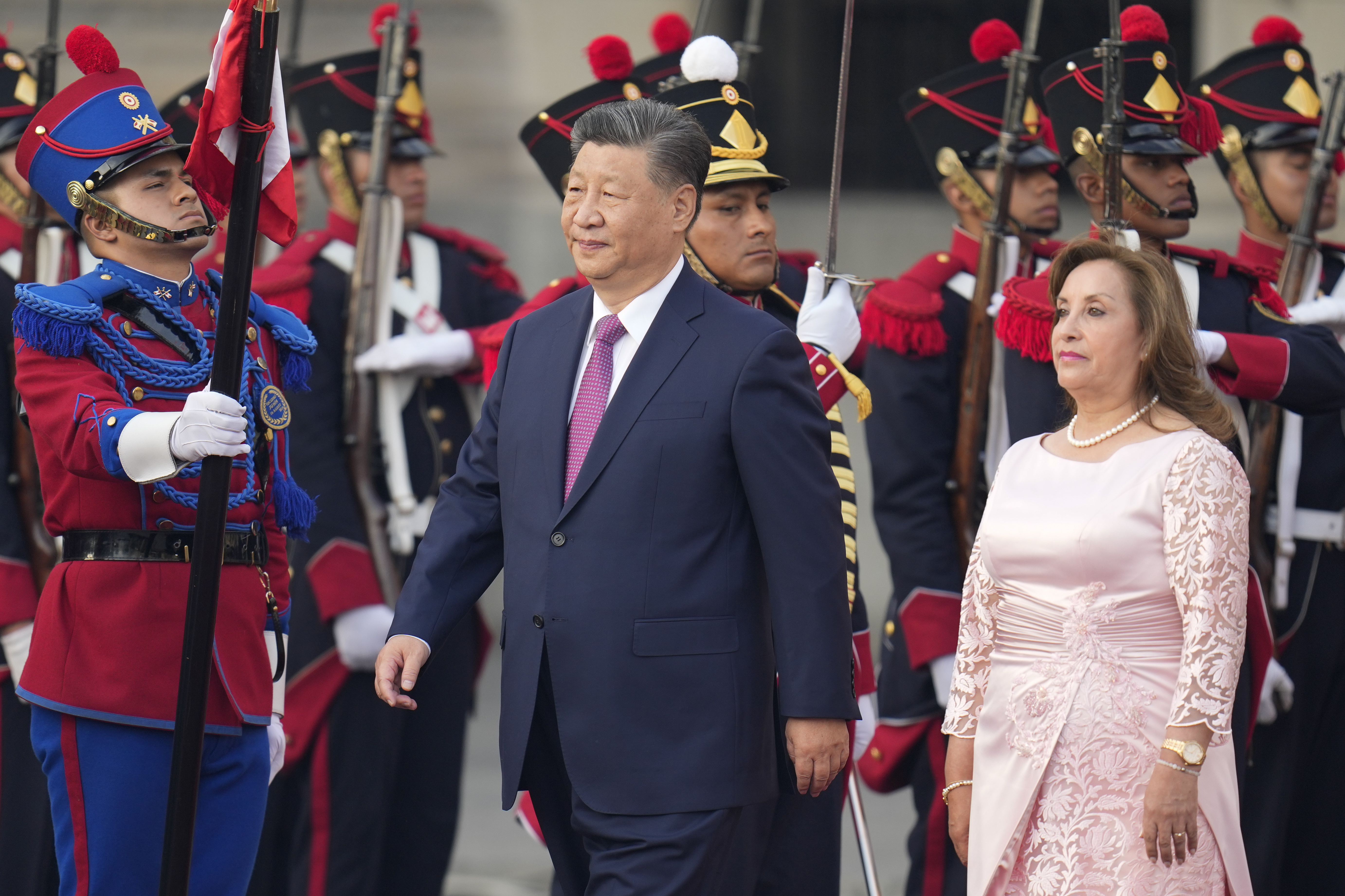 China's President Xi Jinping, center, and Peru's President Dina Boluarte face the honor guard during a welcome ceremony at the government palace in Lima, Peru, Thursday, Nov. 14, 2024, on the sidelines of the Asia-Pacific Economic Cooperation (APEC) summit. (AP Photo/Fernando Vergara)