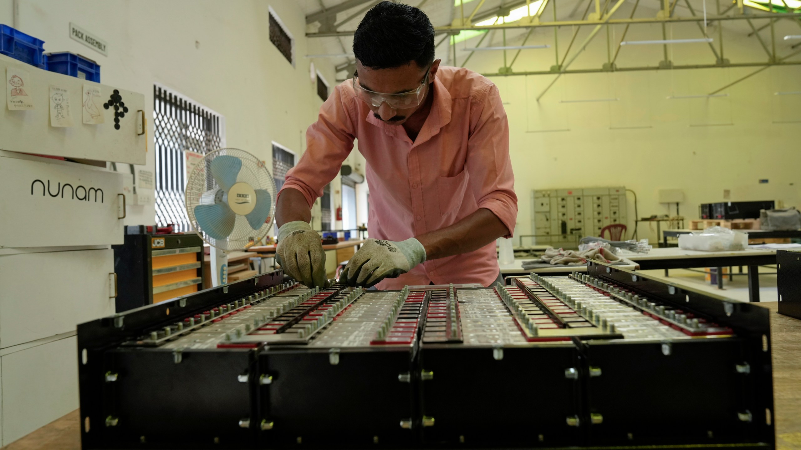 Sandip Varute, a battery production engineer at Nunam, assembles a refurbished battery pack, made from used electric vehicle batteries, at their facility in Bengaluru, India, Tuesday, Oct. 8, 2024. (AP Photo/Aijaz Rahi)