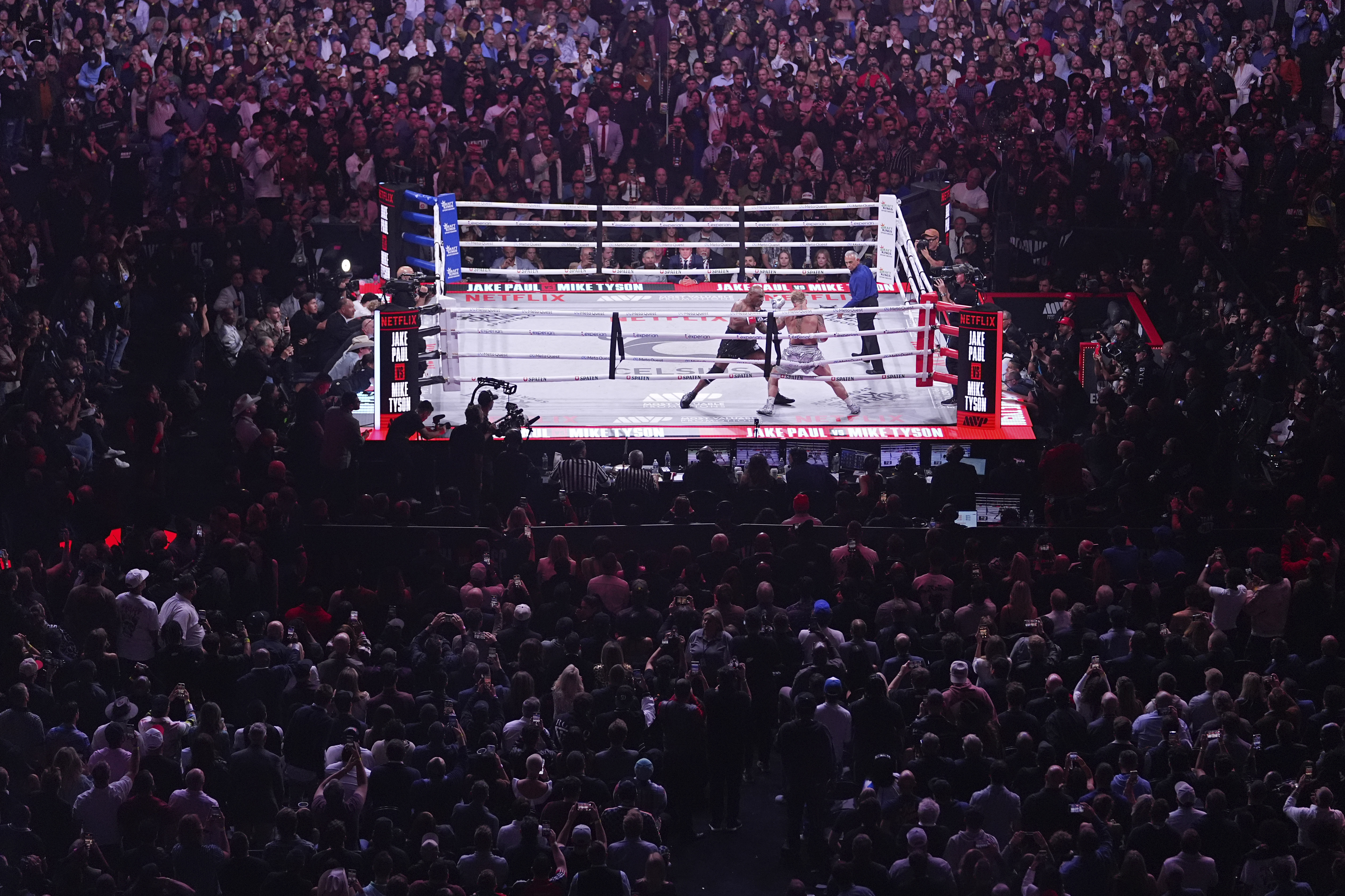 Mike Tyson, left, fights Jake Paul during their heavyweight boxing match, Friday, Nov. 15, 2024, in Arlington, Texas. (AP Photo/Julio Cortez)