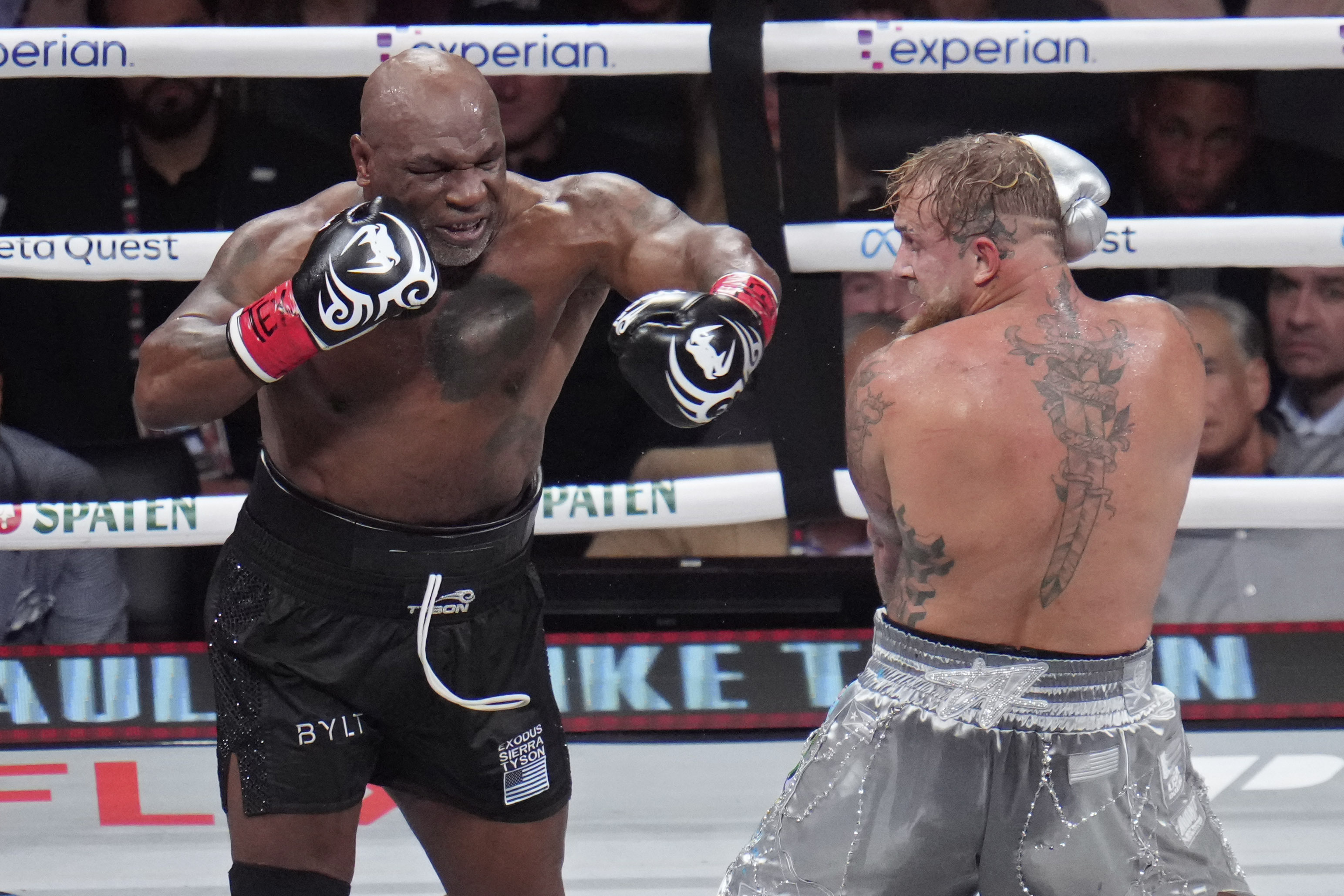 Mike Tyson, left, fights Jake Paul during their heavyweight boxing match, Friday, Nov. 15, 2024, in Arlington, Texas. (AP Photo/Julio Cortez)