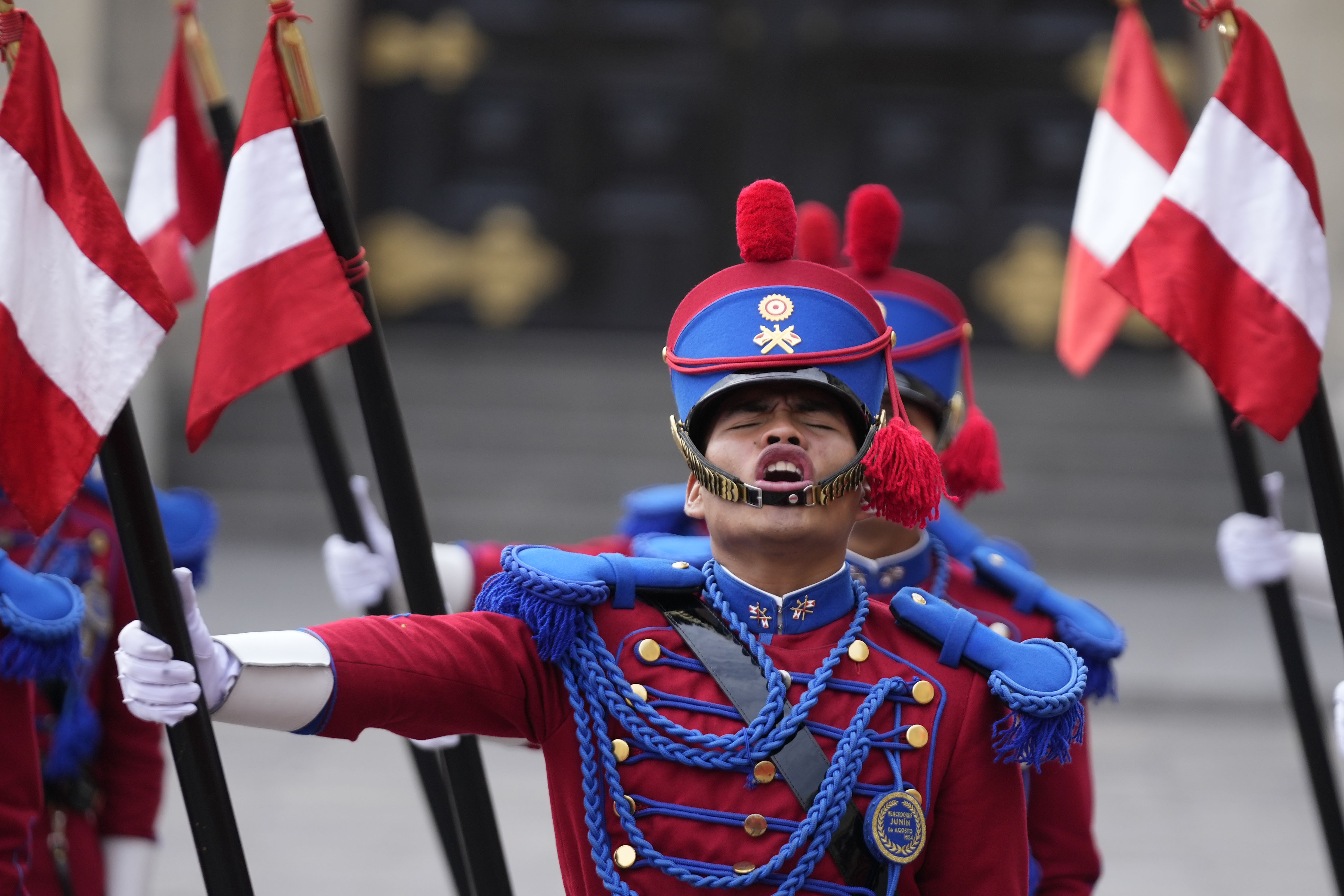 A Peruvian honor guard sing their national anthem during a welcoming ceremony for South Korea's President Yoon Suk Yeol at the government palace in Lima, Peru, Saturday, Nov. 16, 2024, following the closing of the Asia-Pacific Economic Cooperation (APEC) summit. (AP Photo/Fernando Vergara)