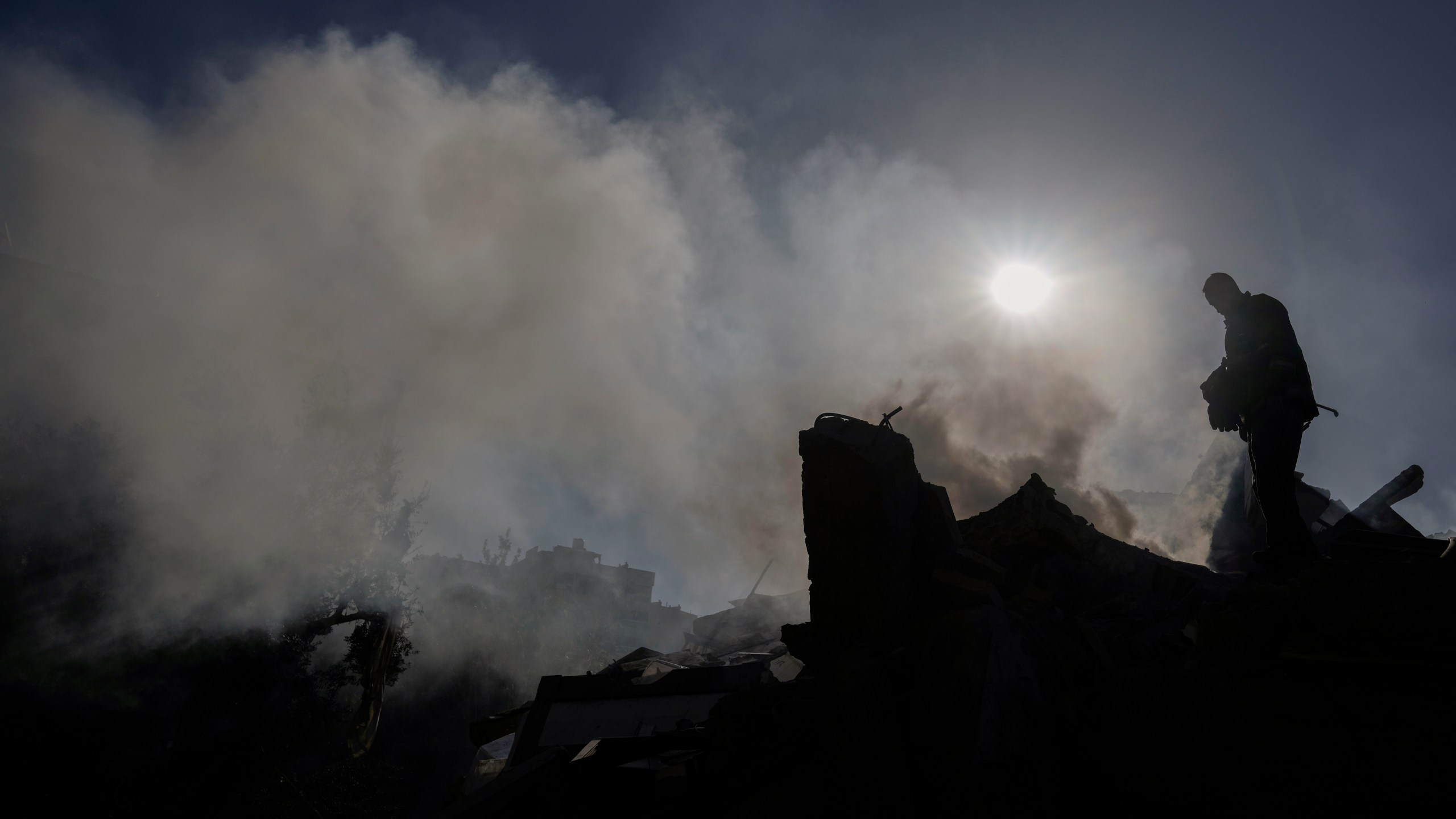 A civil defense worker checks a building that collapsed after it was hit in an Israeli airstrike in Hadath, south of Beirut, Lebanon, Sunday, Nov. 17, 2024. (AP Photo/Bilal Hussein)