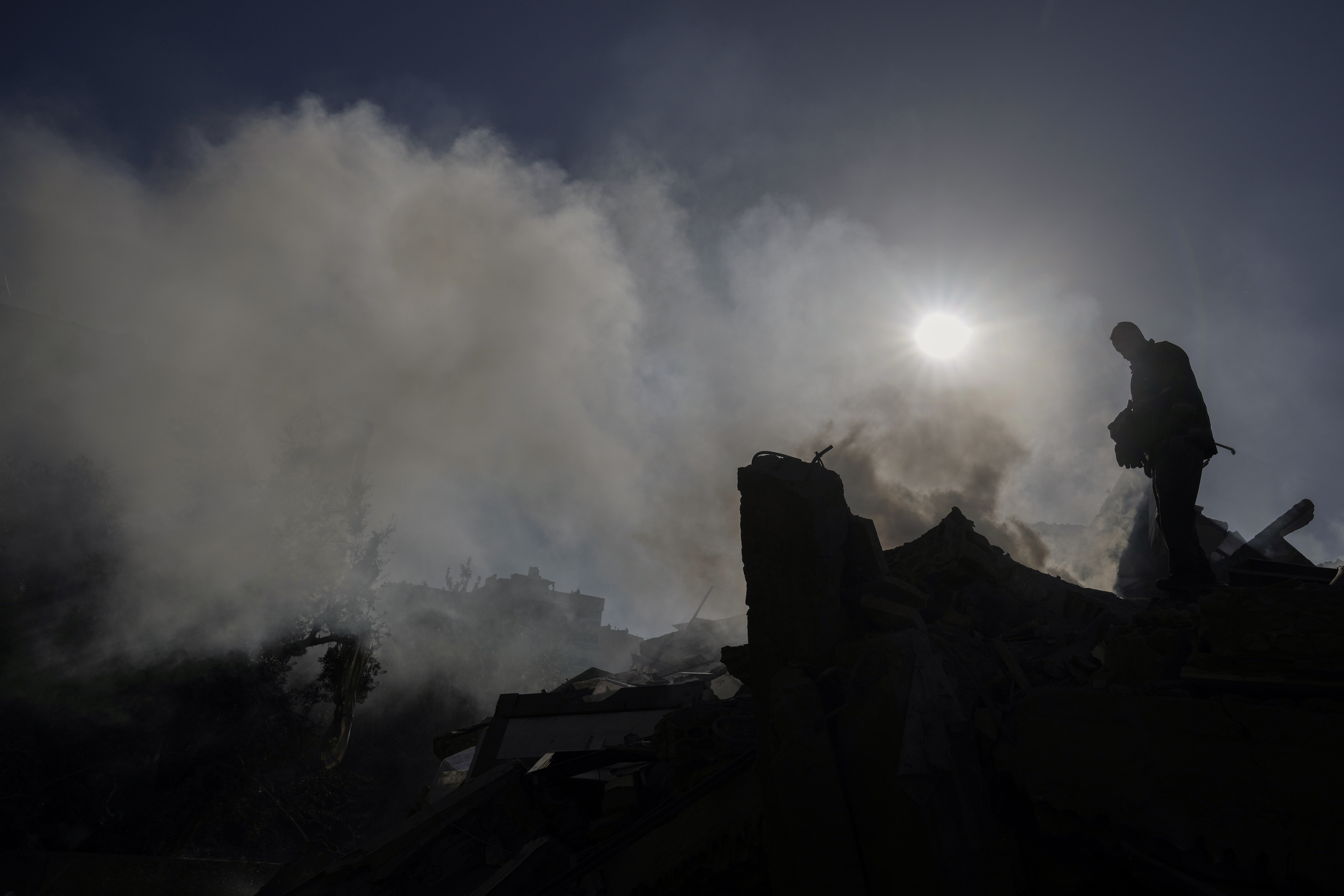 A civil defense worker checks a building that collapsed after it was hit in an Israeli airstrike in Hadath, south of Beirut, Lebanon, Sunday, Nov. 17, 2024. (AP Photo/Bilal Hussein)