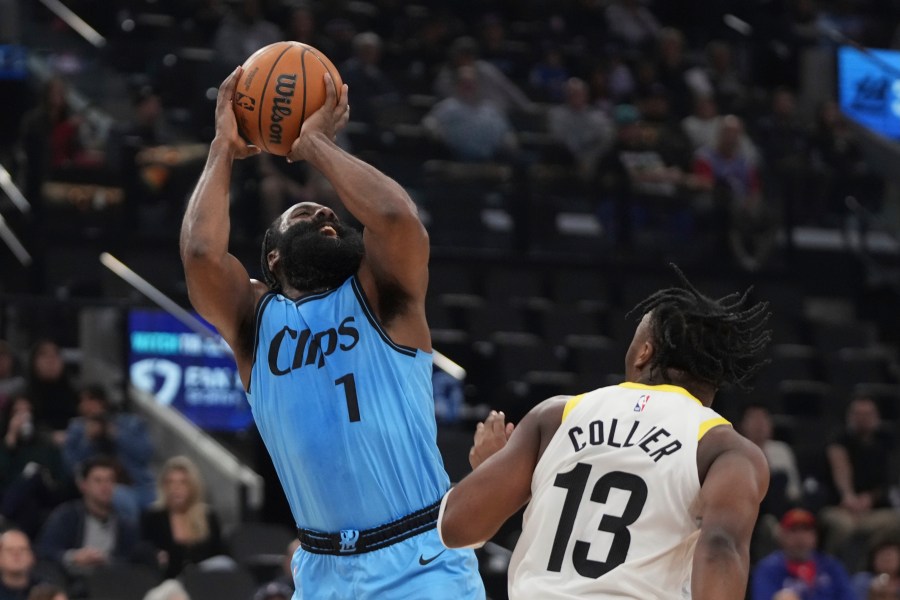 Los Angeles Clippers guard James Harden, left, shoots as Utah Jazz guard Isaiah Collier defends during the first half of an NBA basketball game, Sunday, Nov. 17, 2024, in Inglewood, Calif. (AP Photo/Mark J. Terrill)