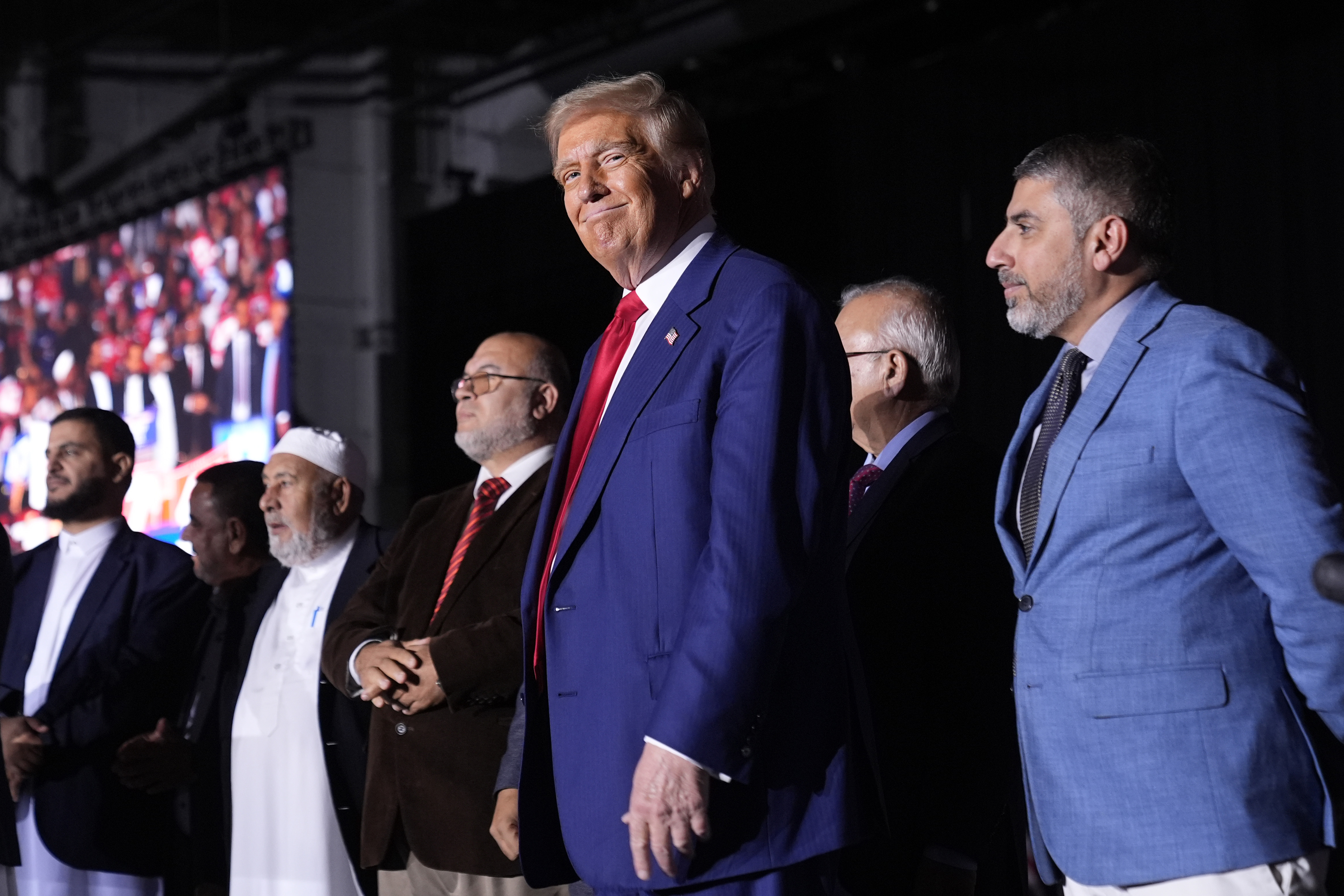 FILE - Republican presidential nominee former President Donald Trump, center, stands alongside local Muslim leaders during a campaign rally, Oct. 26, 2024, in Novi, Mich. (AP Photo/Alex Brandon, File)