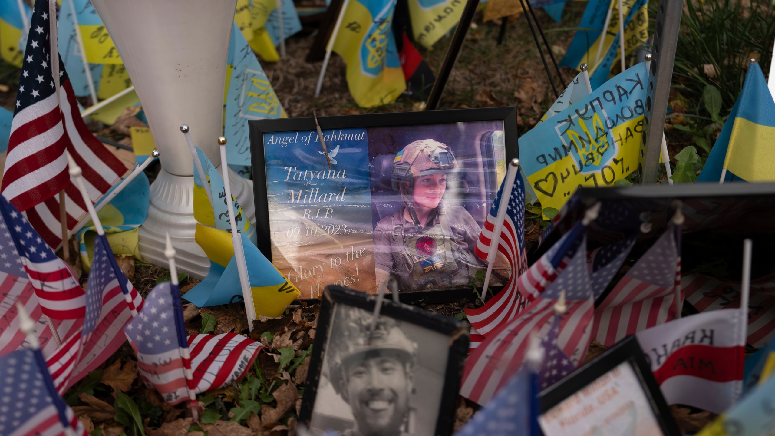 The memorial plate for Tatyana Millard, American volunteer, is seen among Ukrainian and American flags placed in honour of fallen servicemen in Independence Square in central Kyiv, Ukraine, Tuesday, Nov. 5, 2024. (AP Photo/Alex Babenko)