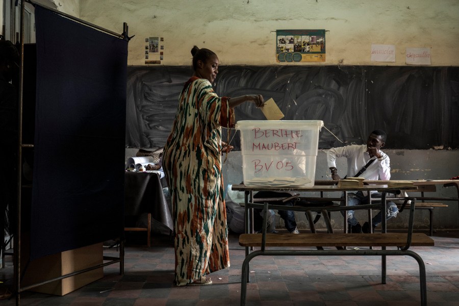 A woman casts her vote for legislative elections, at a polling station in Dakar, Senegal Sunday, Nov. 17, 2024. (AP Photo/Annika Hammerschlag)