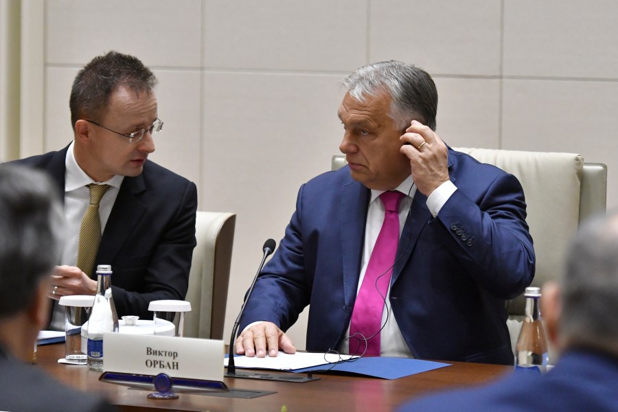 Hungarian Foreign Minister Peter Szijjarto, rear left, and Hungarian Prime Minister Viktor Orban, rear right, attend a meeting with Kyrgyz President Sadyr Japarov at Yntymak Ordo State Residence in Bishkek, Kyrgyzstan, Tuesday, Nov. 5, 2024. (AP Photo/Vladimir Voronin)