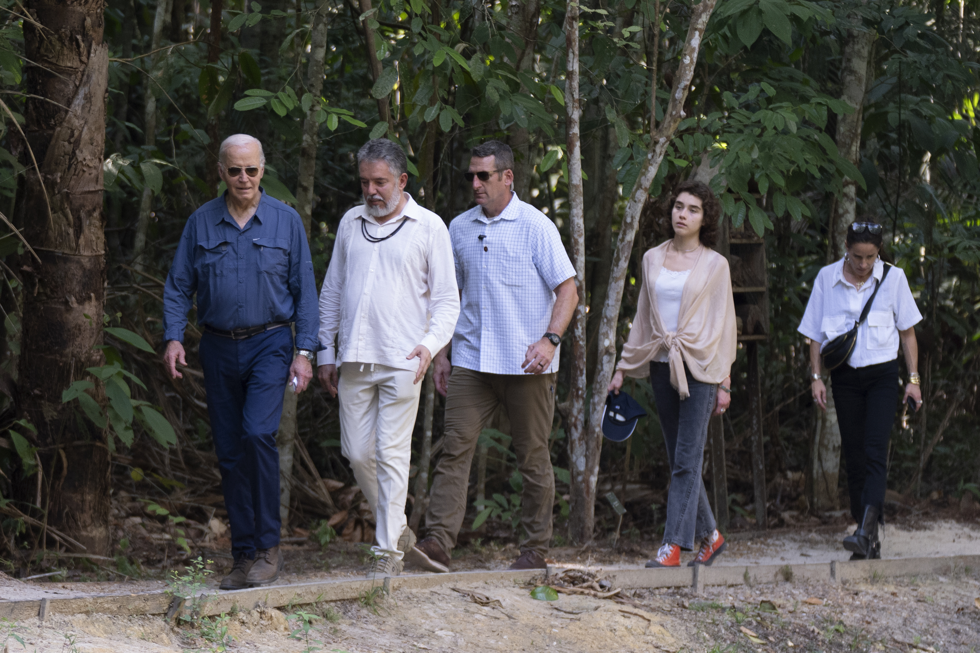 President Joe Biden, from left, walks with Henrique Pereira, director of the National Institute for Research in the Amazon, granddaughter Natalie Biden, second right, and daughter Ashley Biden, right, during a tour of the Museu da Amazonia in Manaus, Brazil, Sunday, Nov. 17, 2024. (AP Photo/Manuel Balce Ceneta)