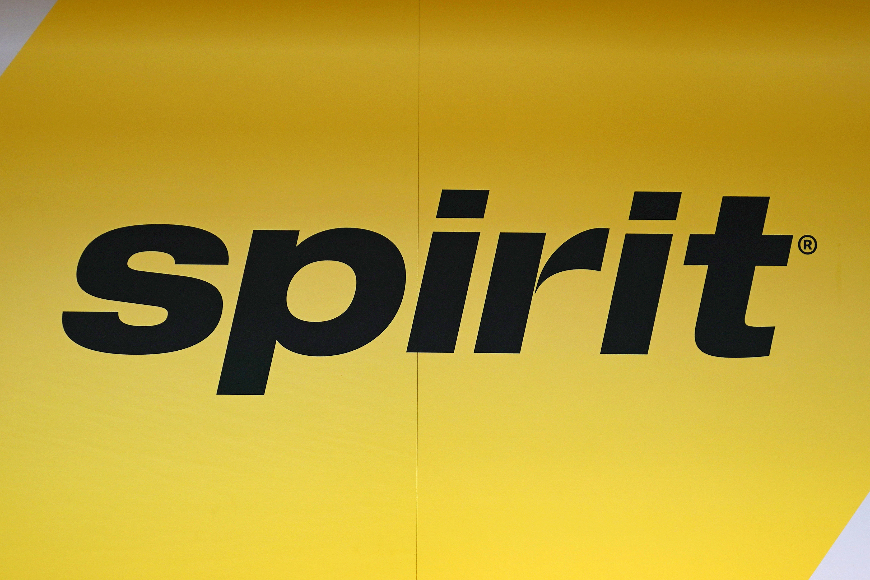 FILE - The Spirit Airlines logo is seen at the ticket counter at Manchester Boston Regional Airport, on June 2, 2023, in Manchester, N.H. (AP Photo/Charles Krupa, File)