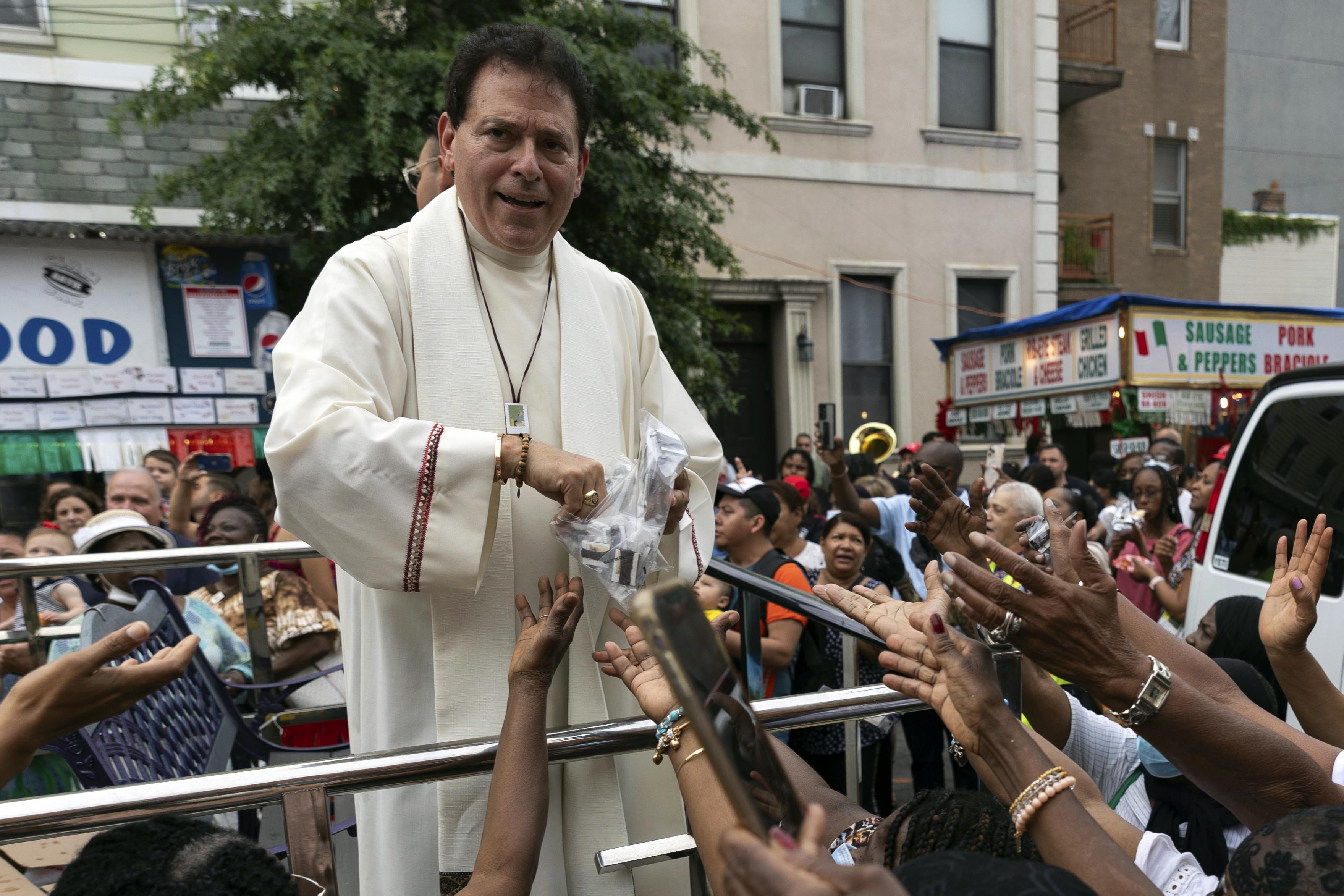 FILE- Former pastor of Shrine Church of Our Lady of Mount Carmel Monsignor Jamie Gigantiello speaks with parishioners, July 16, 2022, in the Brooklyn borough of New York. (AP Photo/Julia Demaree Nikhinson), File