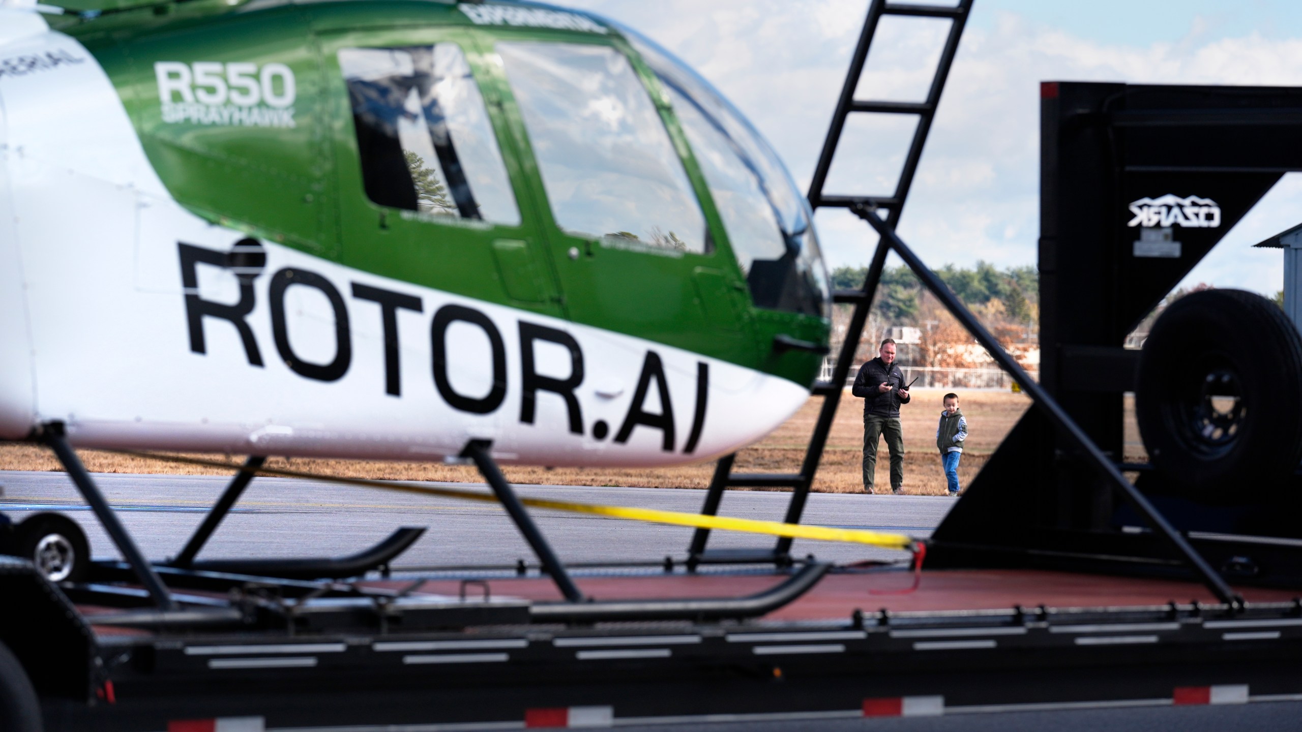 Christian Nowosiadly and his son Logan, 5, watches as a a hanger at the Rotor Technologies , Monday, Nov. 11, 2024, in Nashua, N.H. (AP Photo/Charles Krupa)