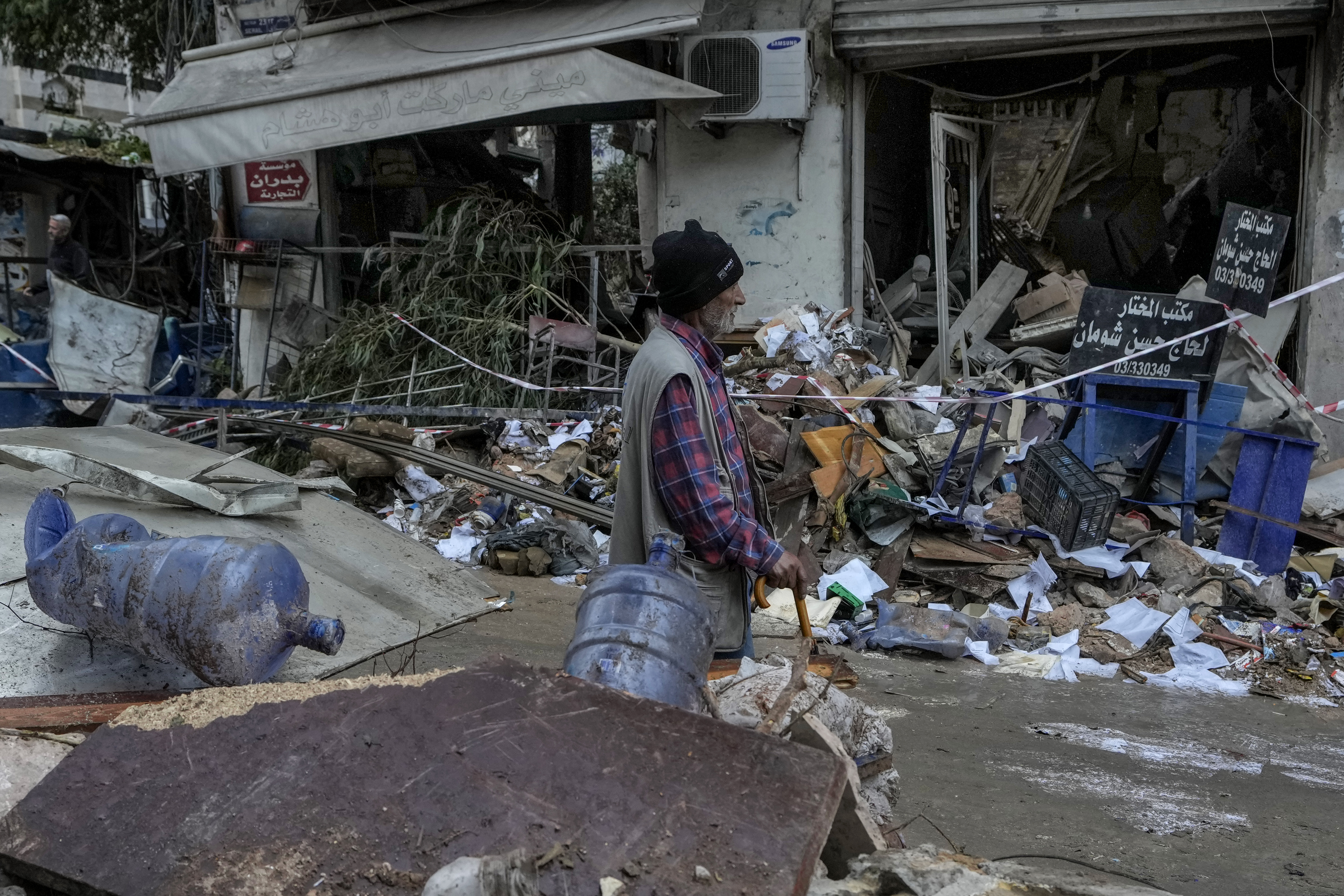 A man passes in front of a destroyed building hit on Monday evening by an Israeli airstrike in central Beirut, Lebanon, Tuesday, Nov. 19, 2024. (AP Photo/Bilal Hussein)