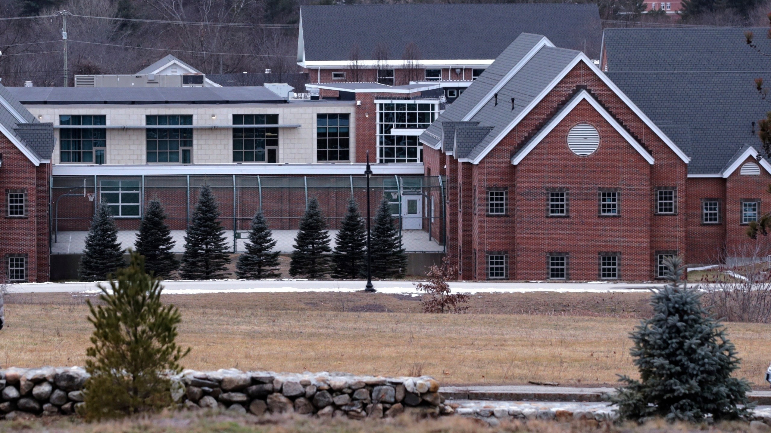 FILE - The Sununu Youth Services Center is seen amongst the trees on Jan. 28, 2020, in Manchester, N.H. (AP Photo/Charles Krupa, File)