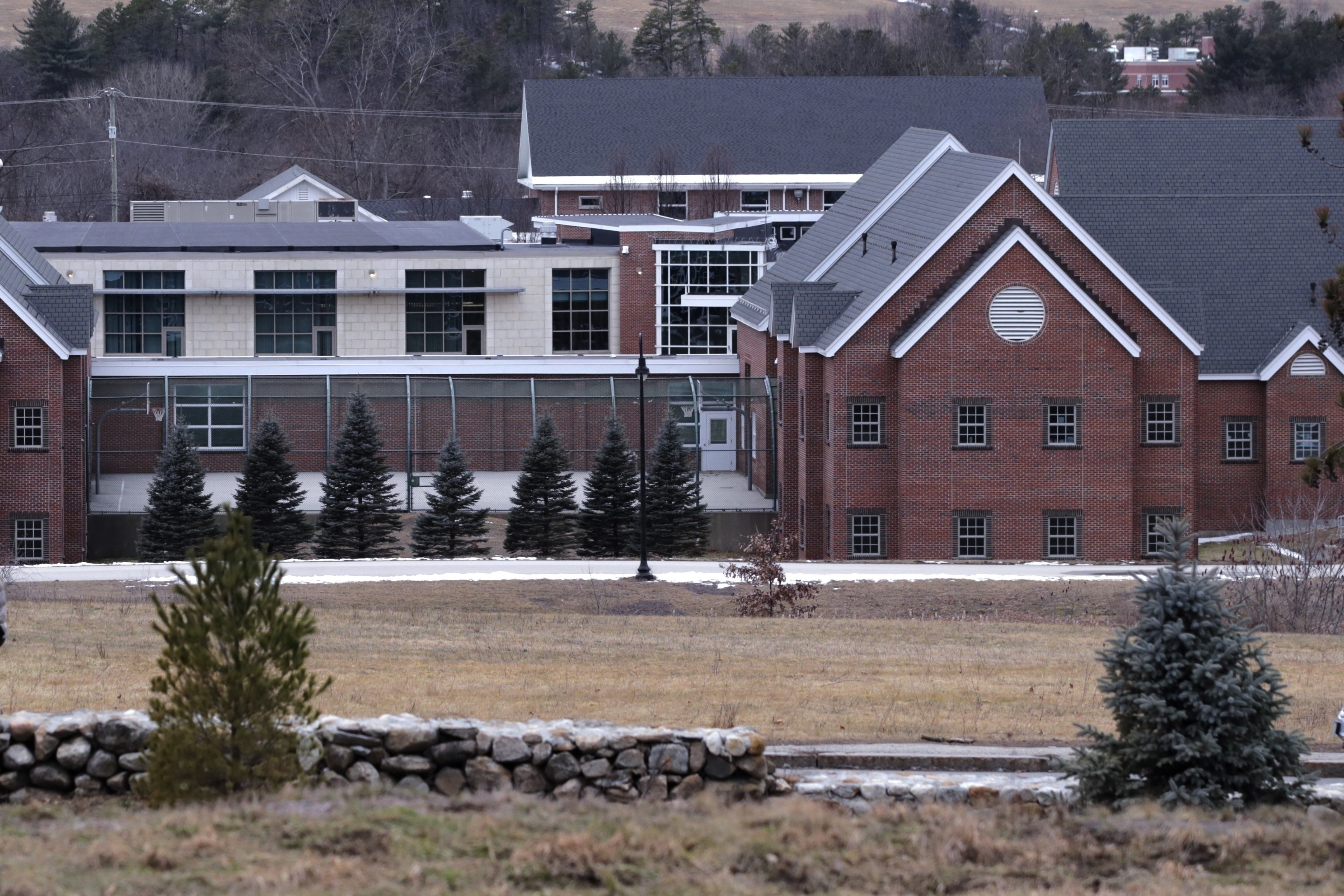 FILE - The Sununu Youth Services Center is seen amongst the trees on Jan. 28, 2020, in Manchester, N.H. (AP Photo/Charles Krupa, File)