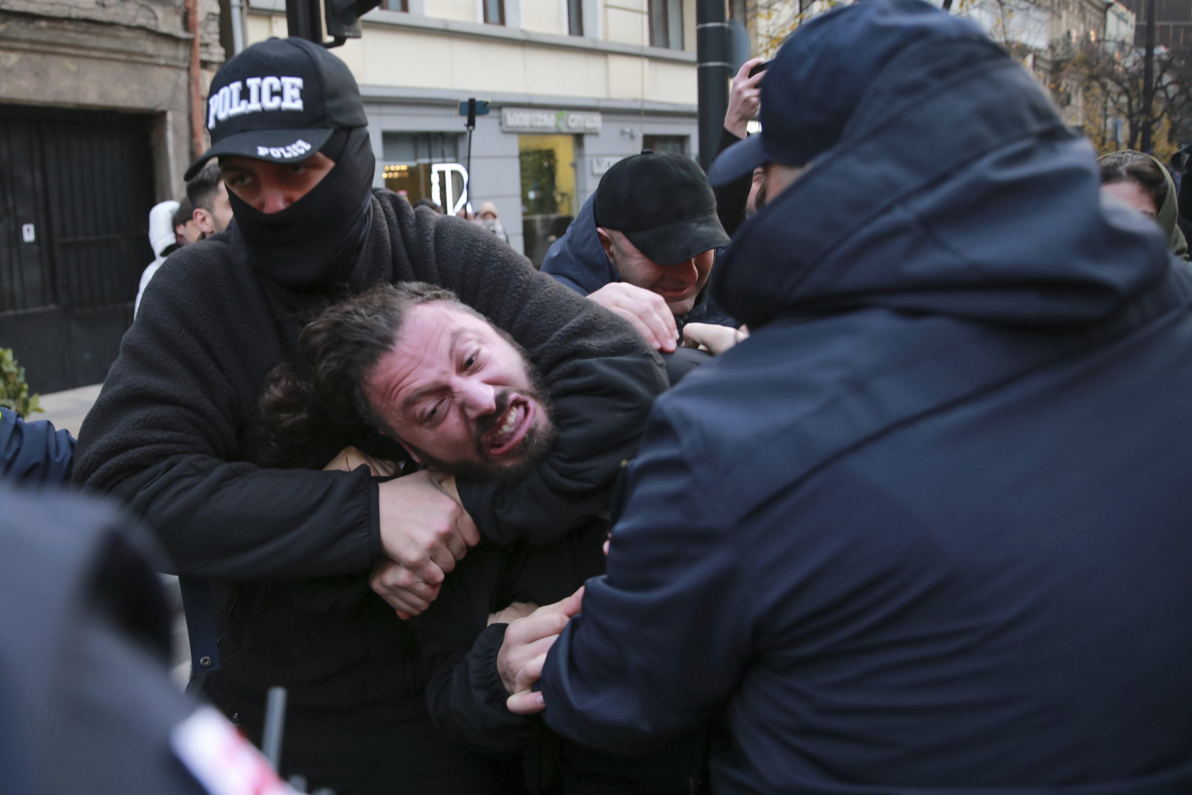 CORRECTS DAY AND DATE: Police try to detain a protester in a street during a rally against the results of the parliamentary elections amid allegations that the vote was rigged in Tbilisi, Georgia, Tuesday, Nov. 19, 2024. (AP Photo/Zurab Tsertsvadze)