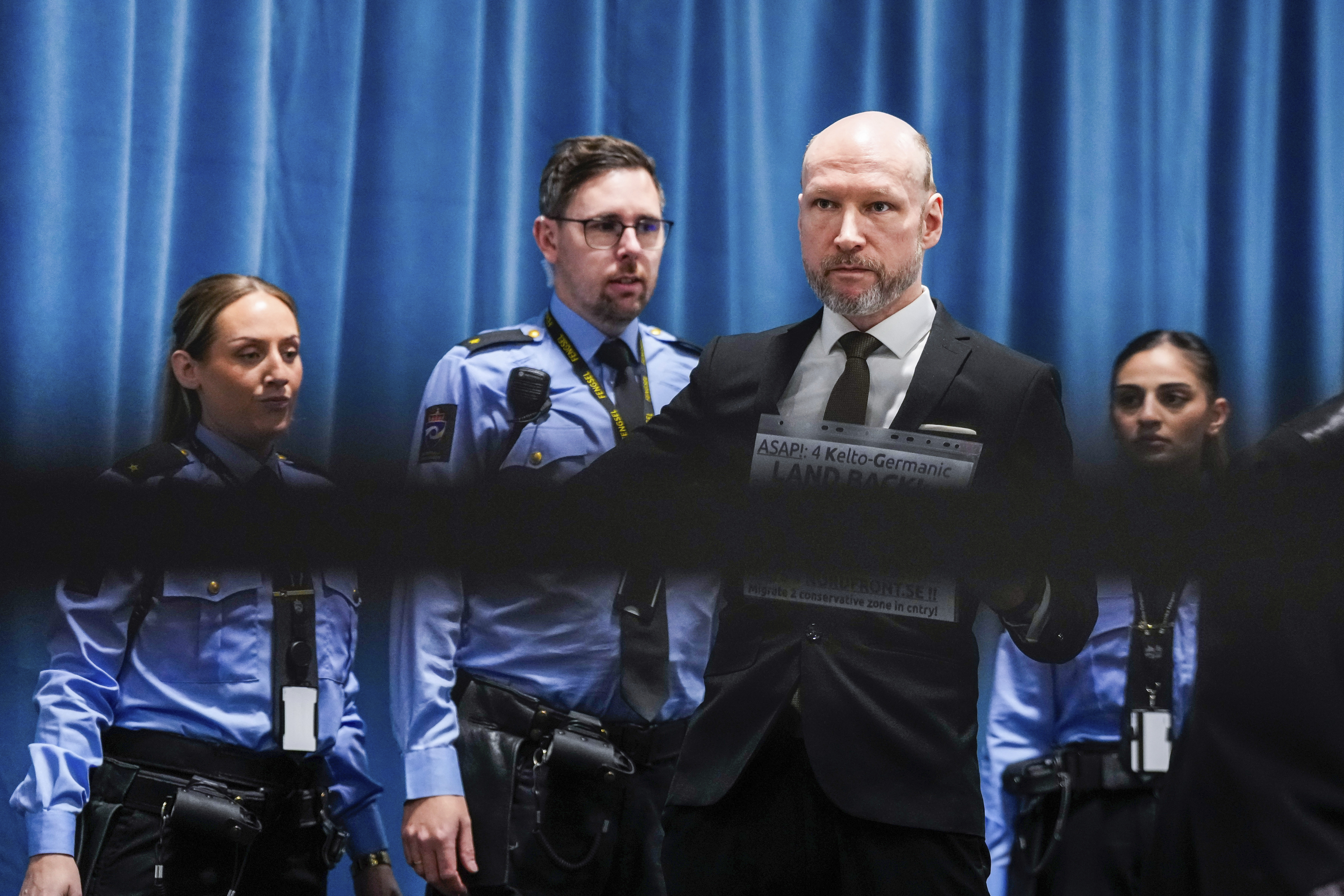 Anders Behring Breivik arrives at the courtroom for day one of the Ringerike, Asker and Bærum district court's processing of Fjotolf Hansen's petition for parole, in Tyristrand, Norway, Tuesday, Nov. 19, 2024. (Beate Oma Dahle/NTB Scanpix via AP)