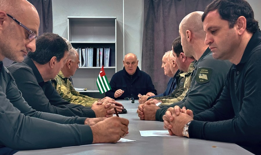 In this photo taken from video released by Information Center of the President of the Republic of Abkhazia on Monday, Nov. 18, 2024, Abkhazian President Aslan Bzhania, center, chairs a Security Council meeting in the village of Tamishi, in Georgia’s breakaway province of Abkhazia. (Information Center of the President of the Republic of Abkhazia via AP)