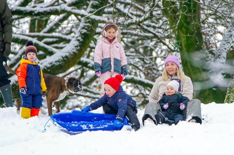 People play in the snow on the hills of Buxton, Derbyshire, Britain, Tuesday, Nov. 19, 2024. (Peter Byrne/PA via AP)