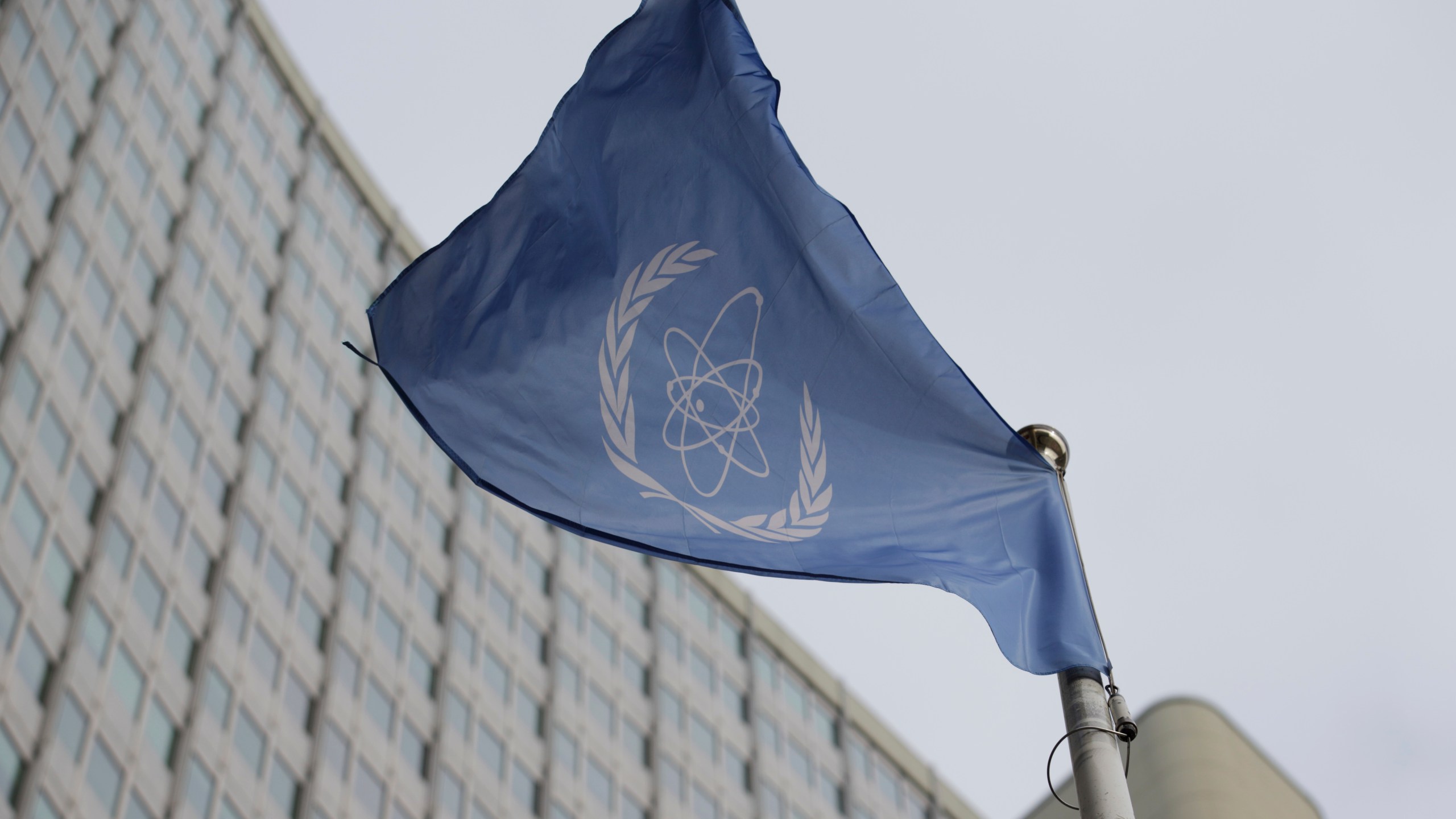 FILE - The flag of the International Atomic Energy Agency flies in front of its headquarters during an IAEA Board of Governors meeting in Vienna, Austria, on Feb. 6, 2023. (AP Photo/Heinz-Peter Bader, File)