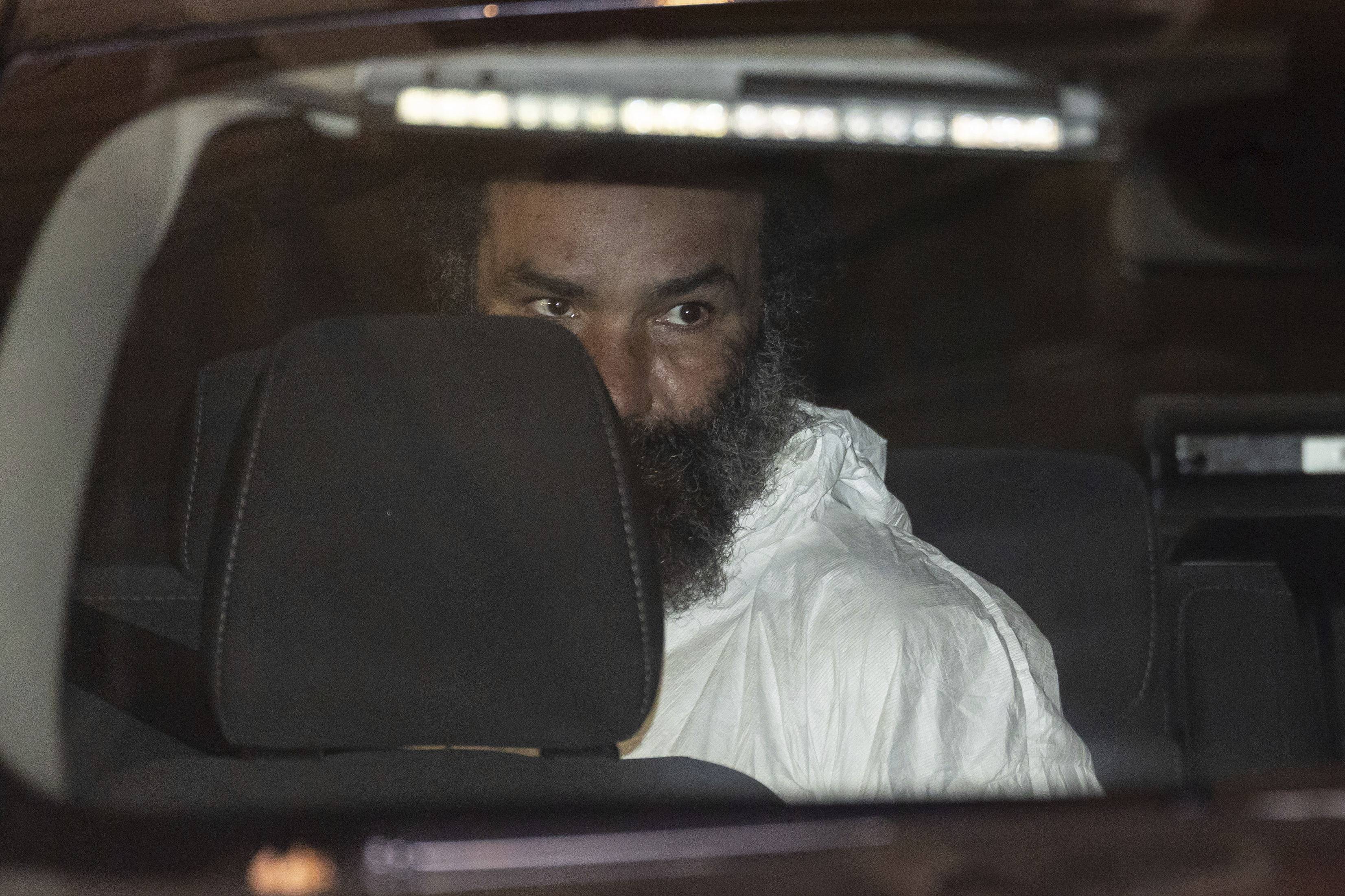 Ramon Rivera, a suspect arrested after multiple people were stabbed early Monday, is escorted out by NYPD officers at the NYPD 10th Precinct in New York, Monday, Nov. 18, 2024. (AP Photo/Yuki Iwamura)