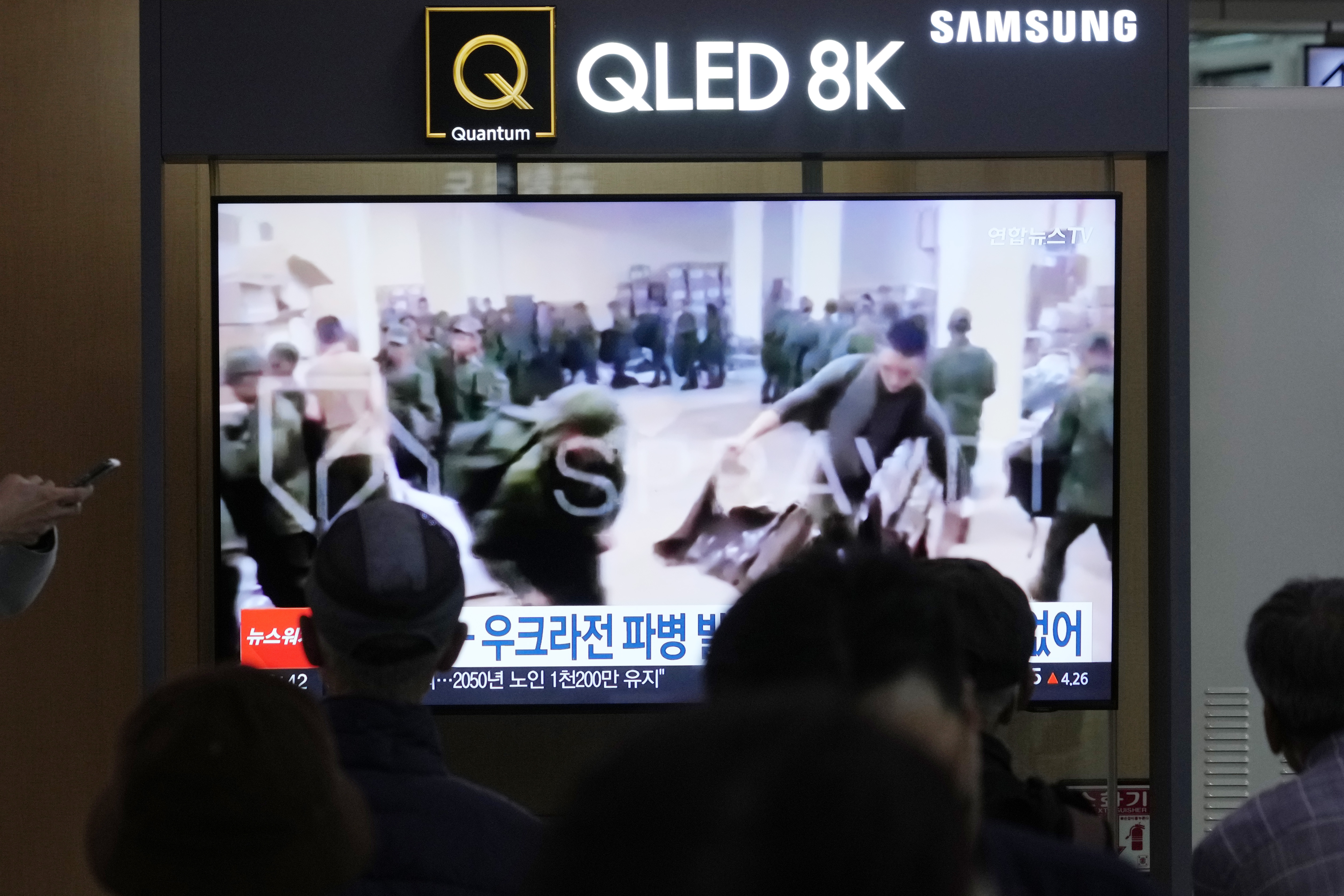 FILE - A TV screen shows an image of soldiers believed to be from North Korea stand in line to receive supplies from Russia during a news program at Seoul Railway Station in Seoul, South Korea, on Oct. 21, 2024. (AP Photo/Ahn Young-joon, File)