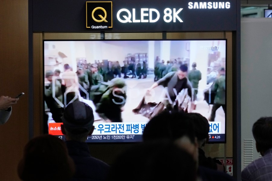 FILE - A TV screen shows an image of soldiers believed to be from North Korea stand in line to receive supplies from Russia during a news program at Seoul Railway Station in Seoul, South Korea, on Oct. 21, 2024. (AP Photo/Ahn Young-joon, File)