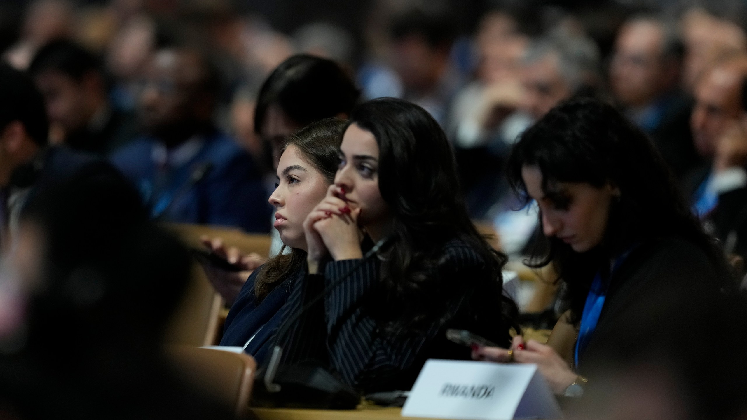 Attendees listen during a session on urbanization at the COP29 U.N. Climate Summit, Wednesday, Nov. 20, 2024, in Baku, Azerbaijan. (AP Photo/Rafiq Maqbool)