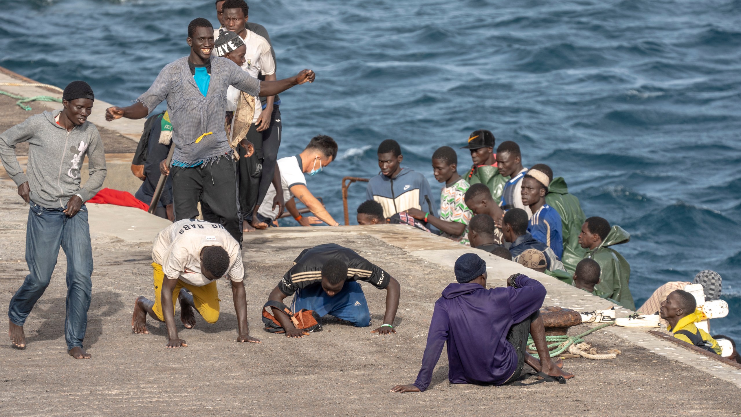 FILE - Migrants react as they arrive at the port in La Restinga on the Canary island of El Hierro, Spain, on, Aug. 19, 2024. (AP Photo/Maria Ximena, File)