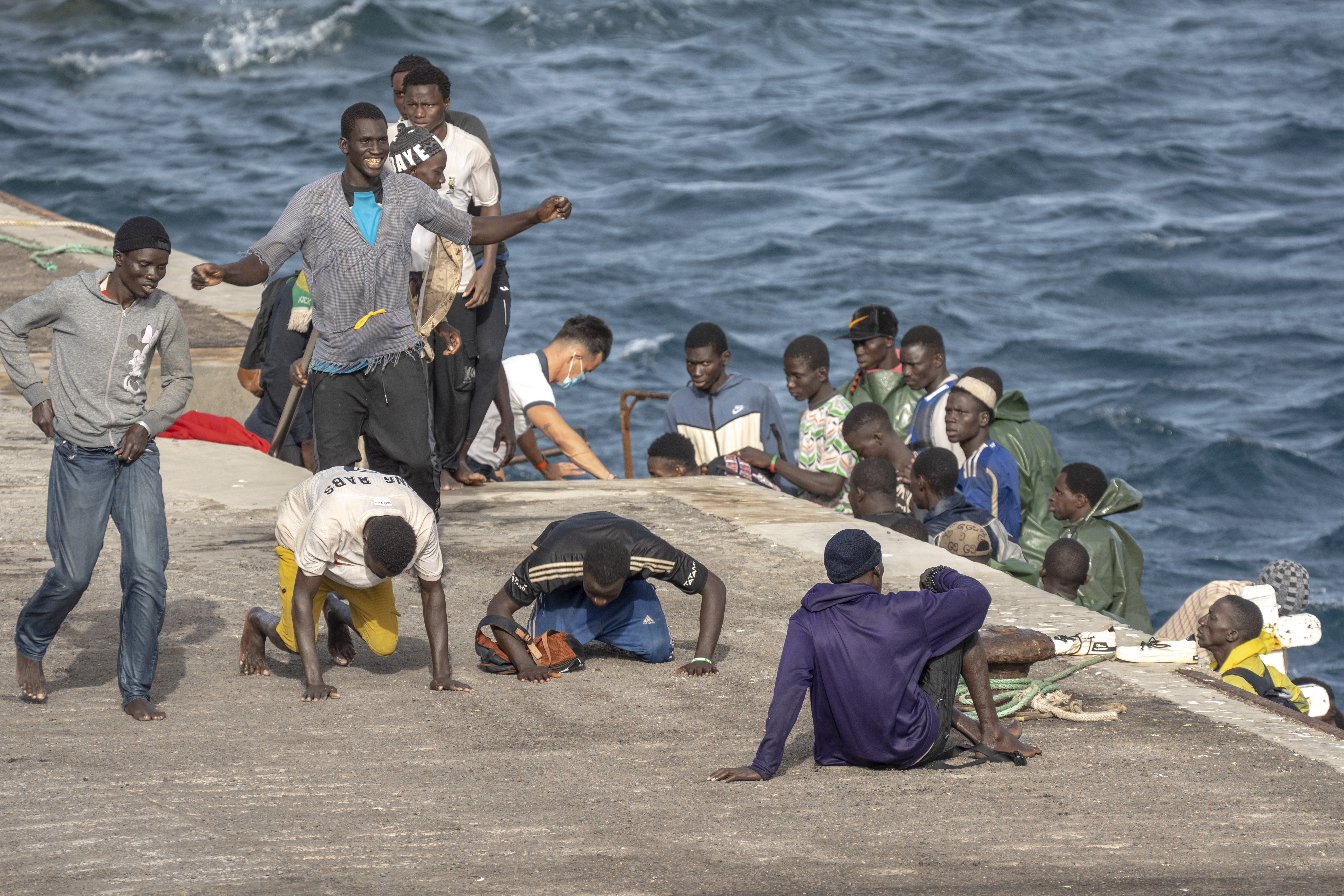 FILE - Migrants react as they arrive at the port in La Restinga on the Canary island of El Hierro, Spain, on, Aug. 19, 2024. (AP Photo/Maria Ximena, File)