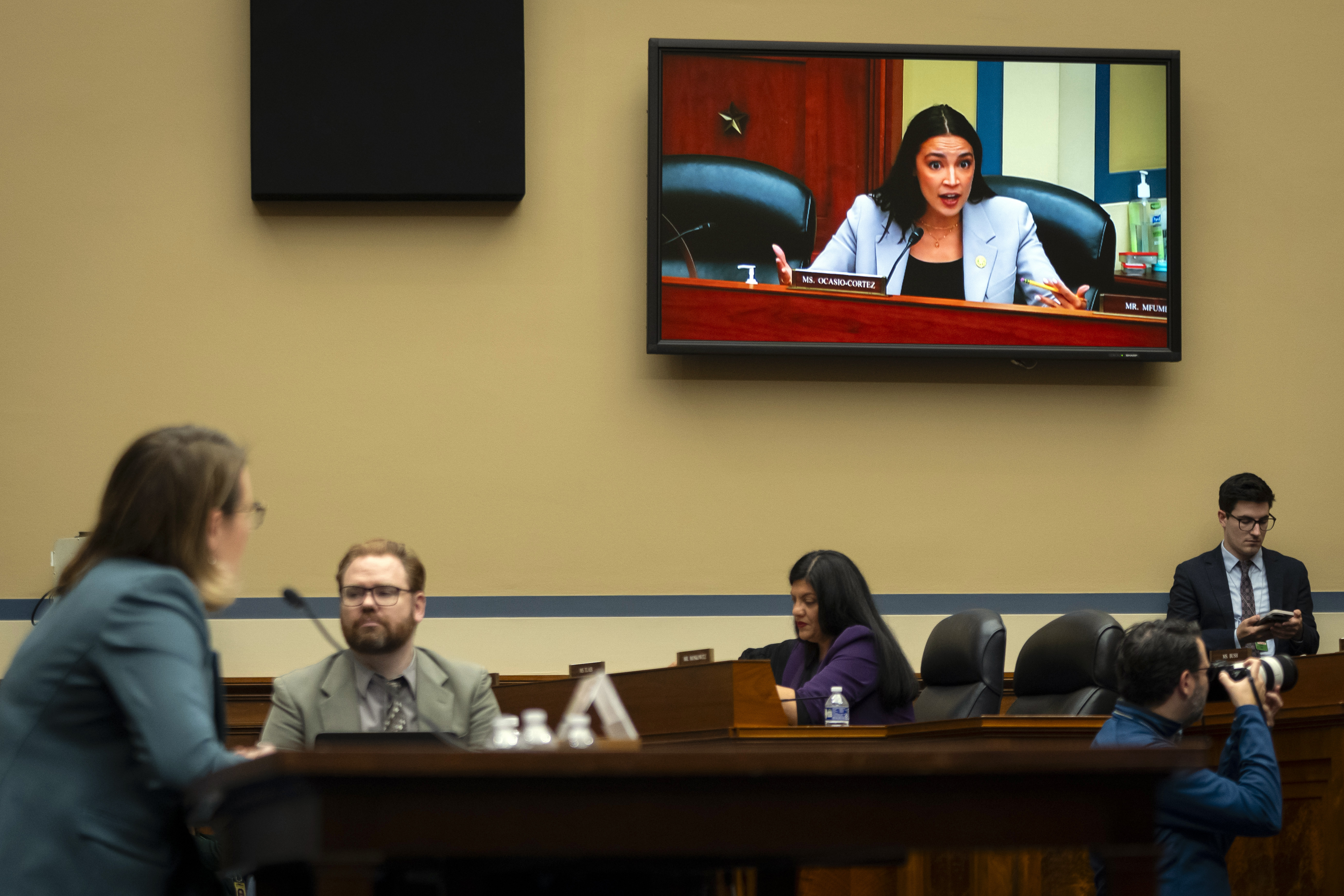 Rep. Alexandria Ocasio-Cortez, D-N.Y., seen on video screen, addresses Administrator of the Federal Emergency Management Agency (FEMA) Deanne Criswell, left, as she testifies in front a House Committee on Oversight and Accountability hearing on oversight of FEMA, on Capitol Hill in Washington, Tuesday, Nov. 19, 2024. (AP Photo/Ben Curtis)