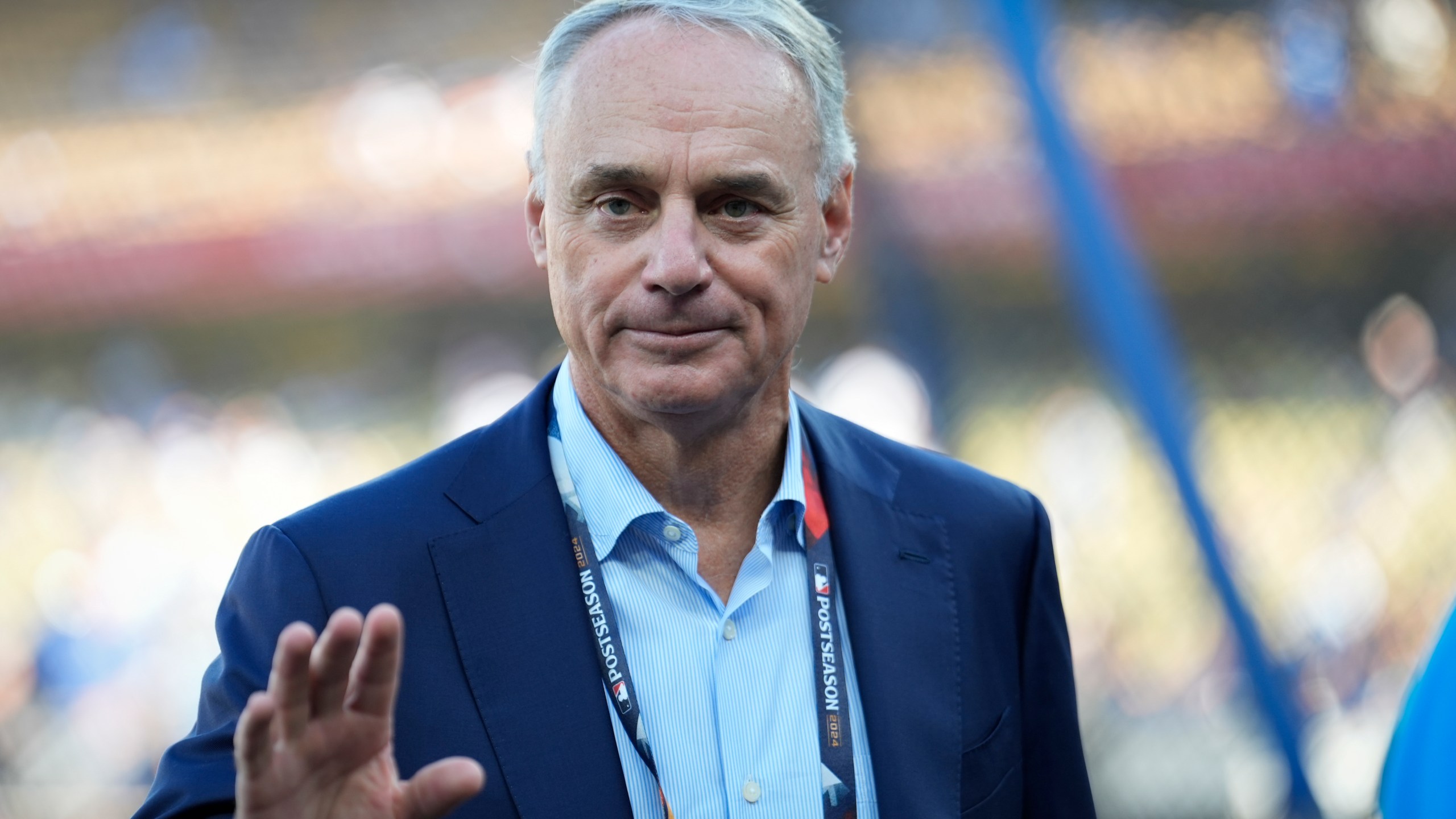 Commissioner of Major League Baseball, Rob Manfred walks on the field before Game 2 of the baseball World Series between the Los Angeles Dodgers and the New York Yankees, Saturday, Oct. 26, 2024, in Los Angeles. (AP Photo/Ashley Landis)