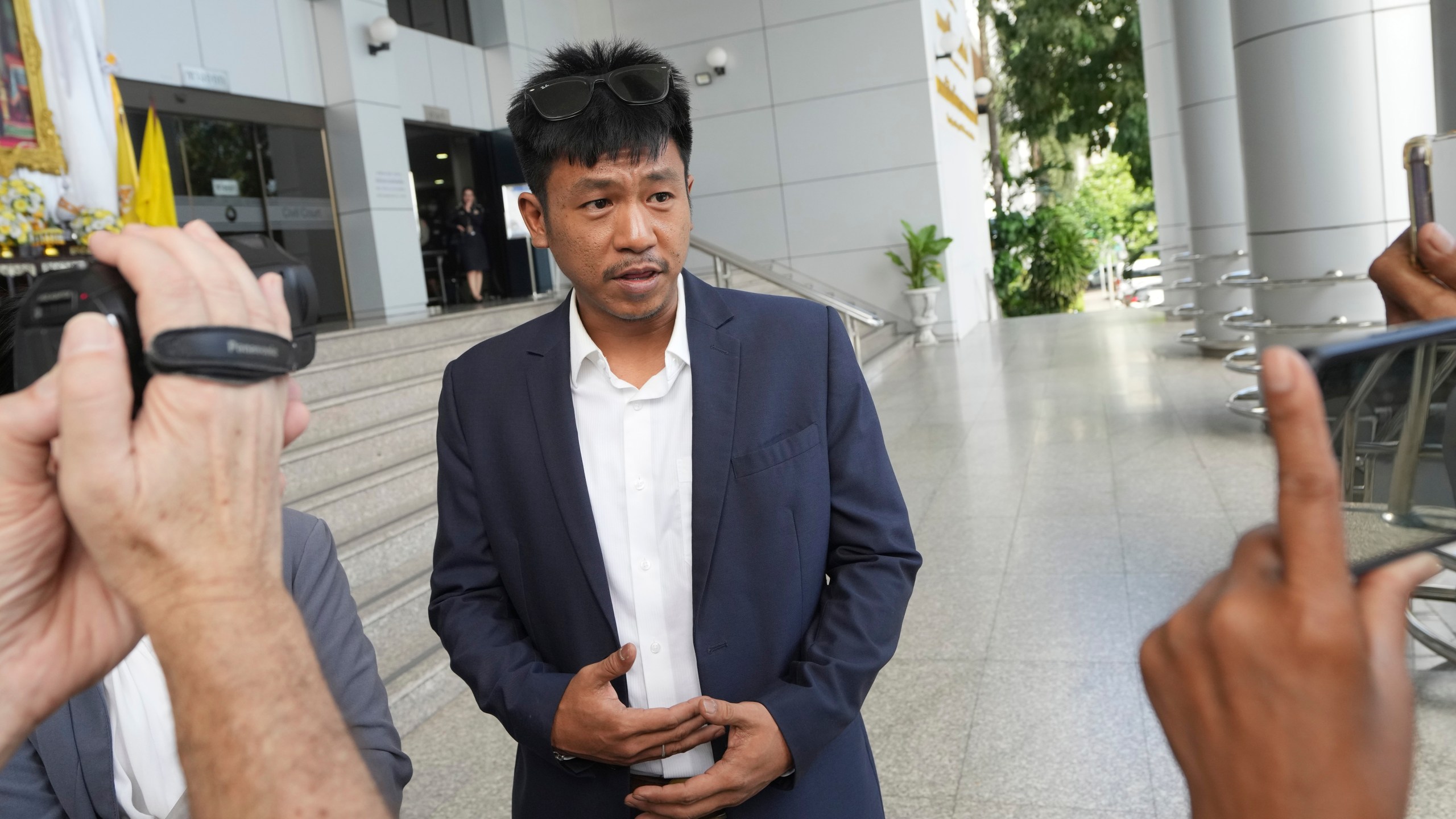 Jatupat Boonpattararaksa talks to reporters before leaving the Civil Court in Bangkok, Thailand, Thursday, Nov. 21, 2024. (AP Photo/Sakchai Lalit)