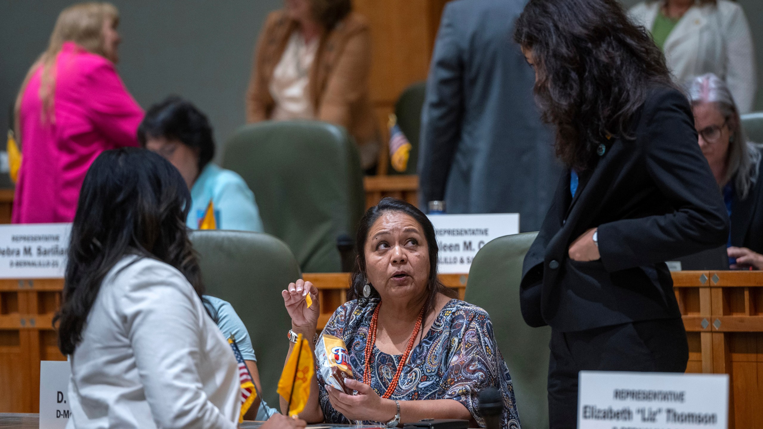 FILE - House Maj. Whip Reena Szczepanski, D-Santa Fe, left, Rep. D. Wonda Johnson, D-Church Rock, center, and Rep. Cristina Parajon, D-Albuquerque, talk before the start of a special session, in Santa Fe, N.M., July 18, 2024. (Eddie Moore/The Albuquerque Journal via AP, File)