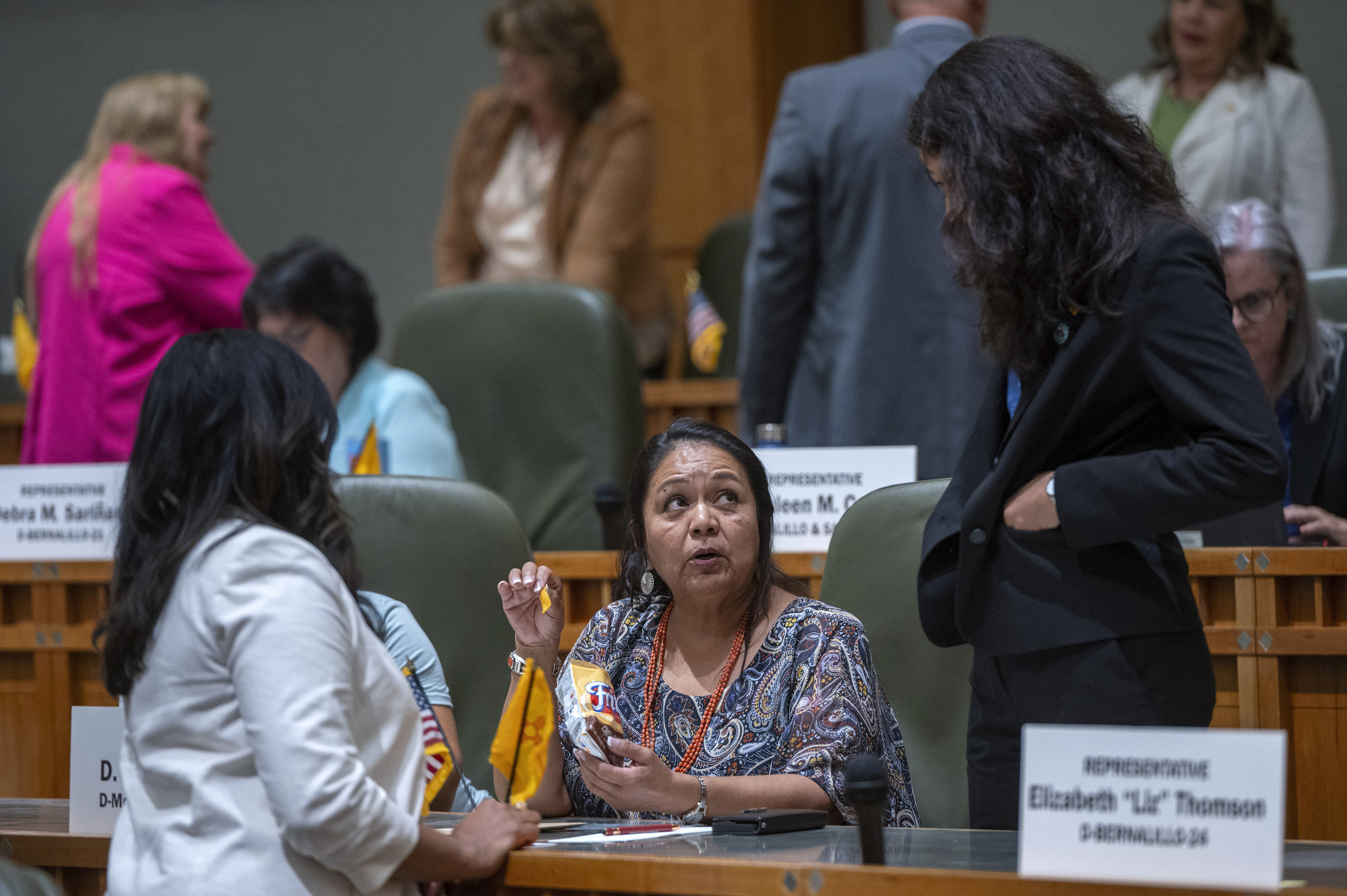 FILE - House Maj. Whip Reena Szczepanski, D-Santa Fe, left, Rep. D. Wonda Johnson, D-Church Rock, center, and Rep. Cristina Parajon, D-Albuquerque, talk before the start of a special session, in Santa Fe, N.M., July 18, 2024. (Eddie Moore/The Albuquerque Journal via AP, File)