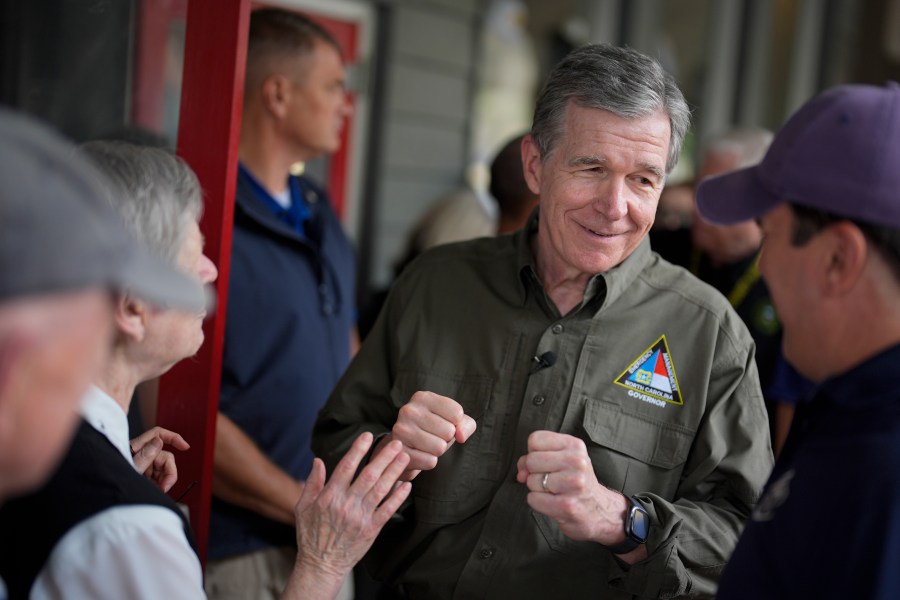 FILE - North Carolina Gov. Roy Cooper greets people, Oct. 3, 2024, in Boone, N.C., in the aftermath of hurricane Helene. (AP Photo/Chris Carlson, File)