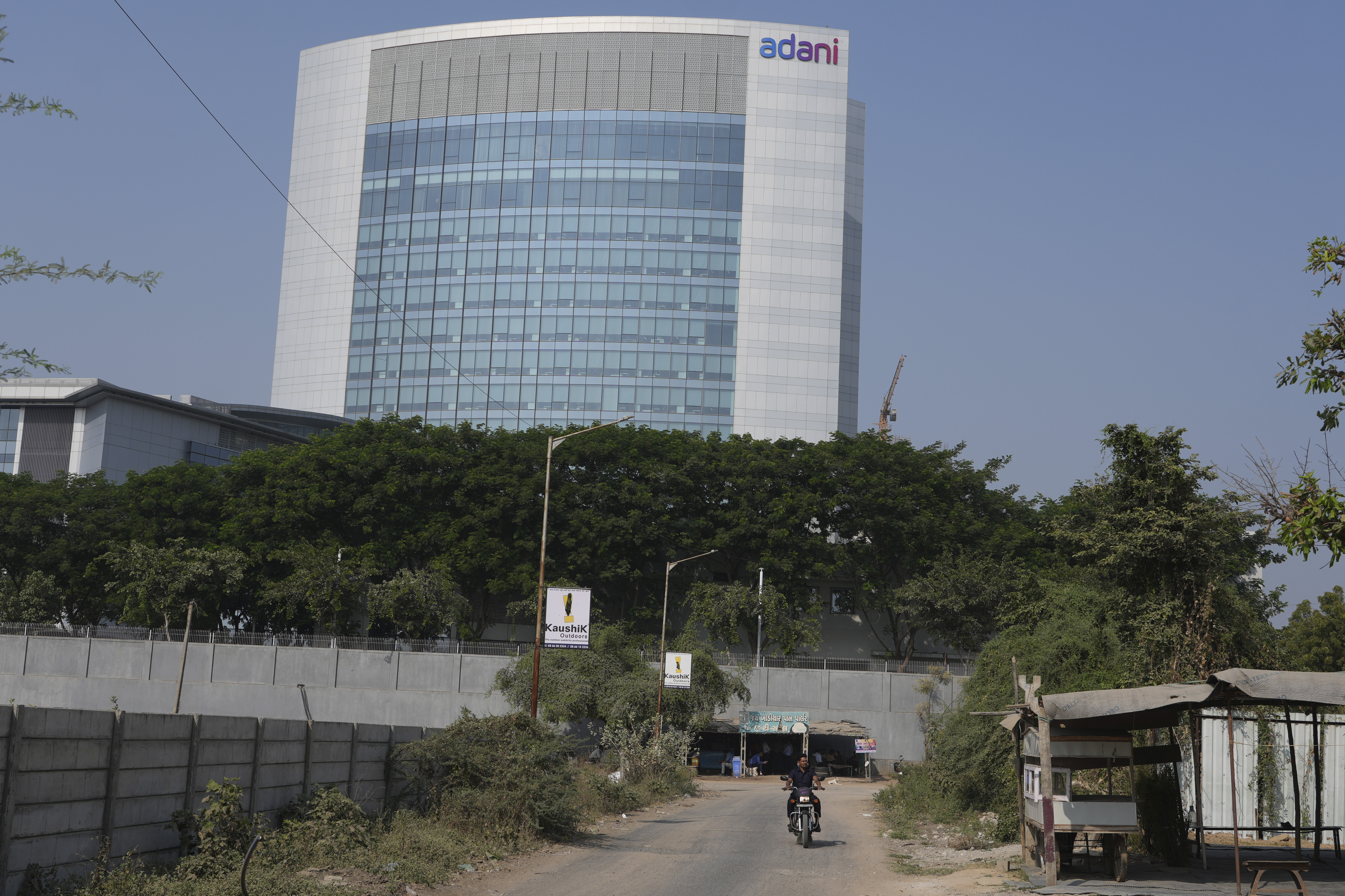 A motorcyclist ride past the Adani's corporate house in Ahmedabad, India, Thursday, Nov. 21, 2024. (AP Photo/Ajit Solanki)