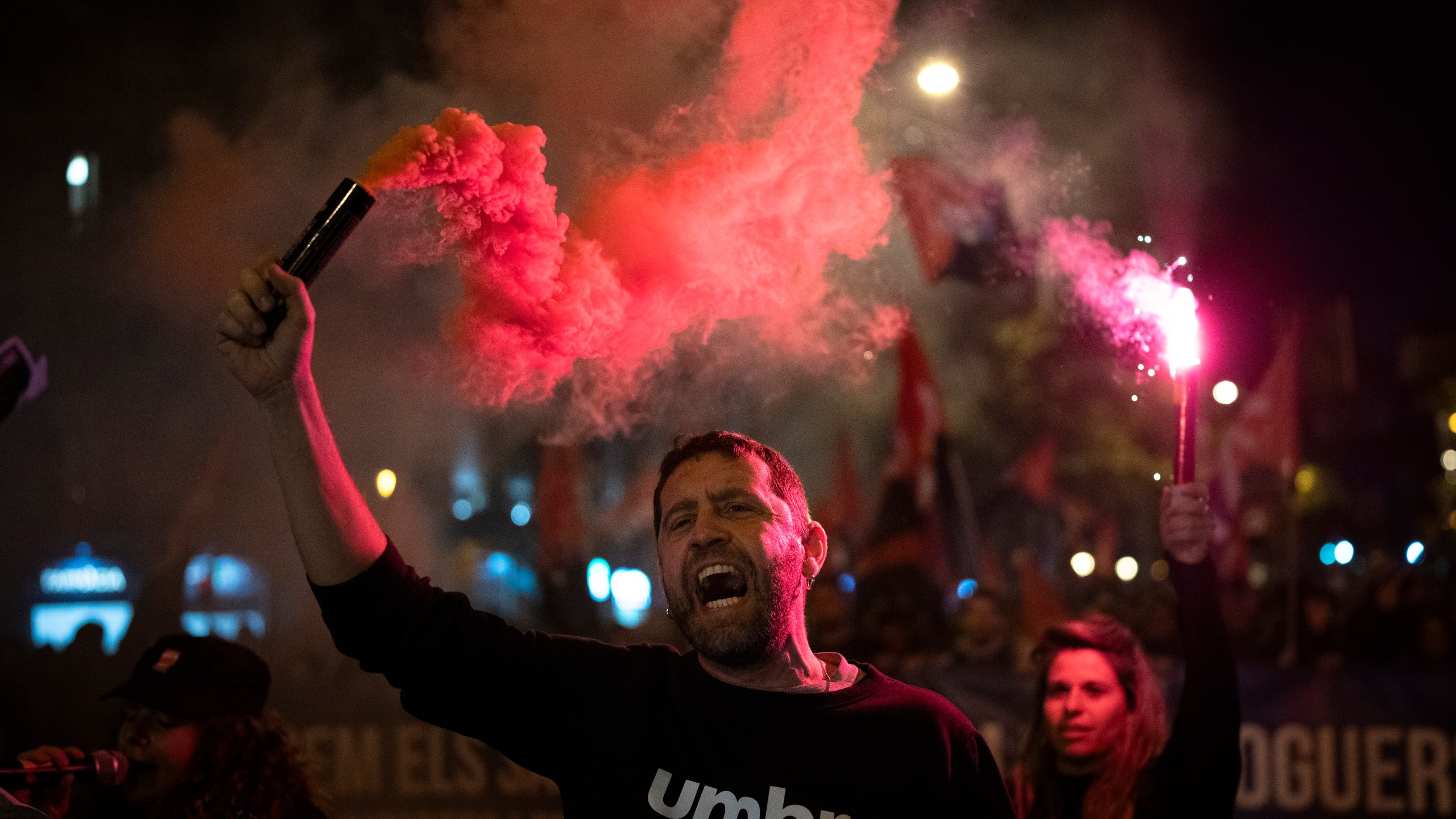 Demonstrators light flares while marching in a protest against the exorbitant rise in the price of renting an apartment in Barcelona, Spain, Saturday, Nov. 23, 2024. (AP Photo/Emilio Morenatti)