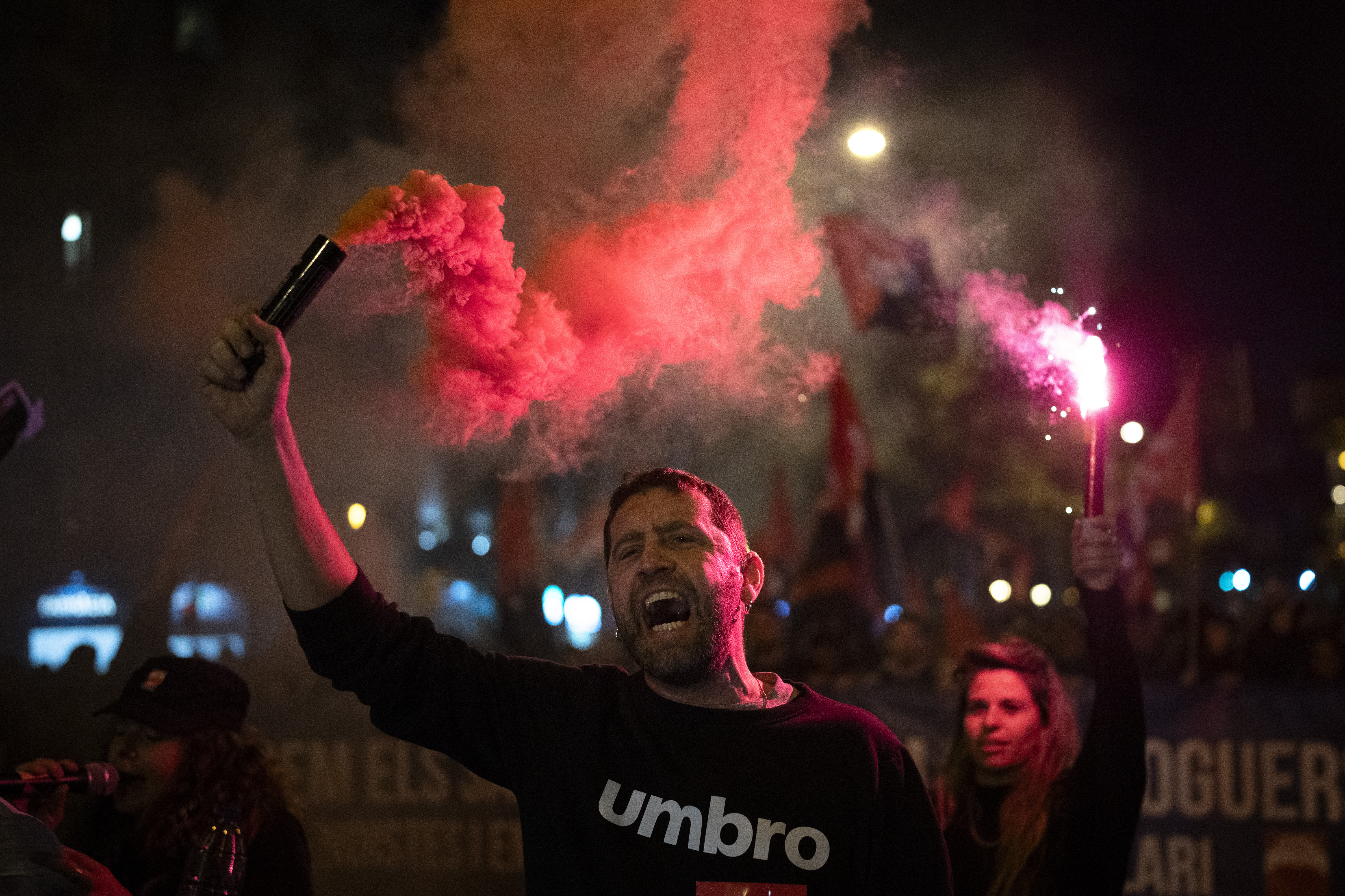 Demonstrators light flares while marching in a protest against the exorbitant rise in the price of renting an apartment in Barcelona, Spain, Saturday, Nov. 23, 2024. (AP Photo/Emilio Morenatti)