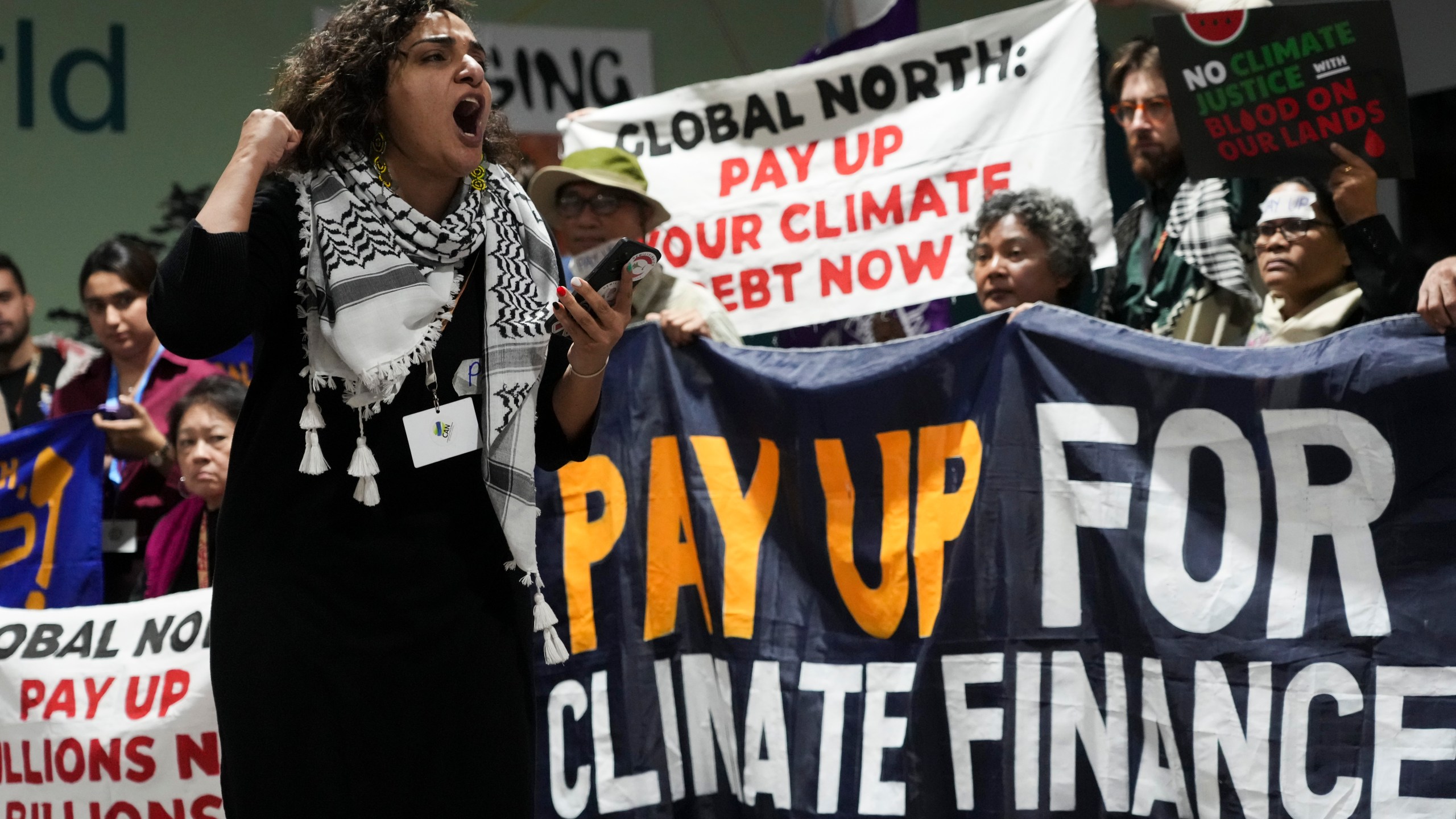 Activists participate in a demonstration for climate finance at the COP29 U.N. Climate Summit, Friday, Nov. 22, 2024, in Baku, Azerbaijan. (AP Photo/Sergei Grits)