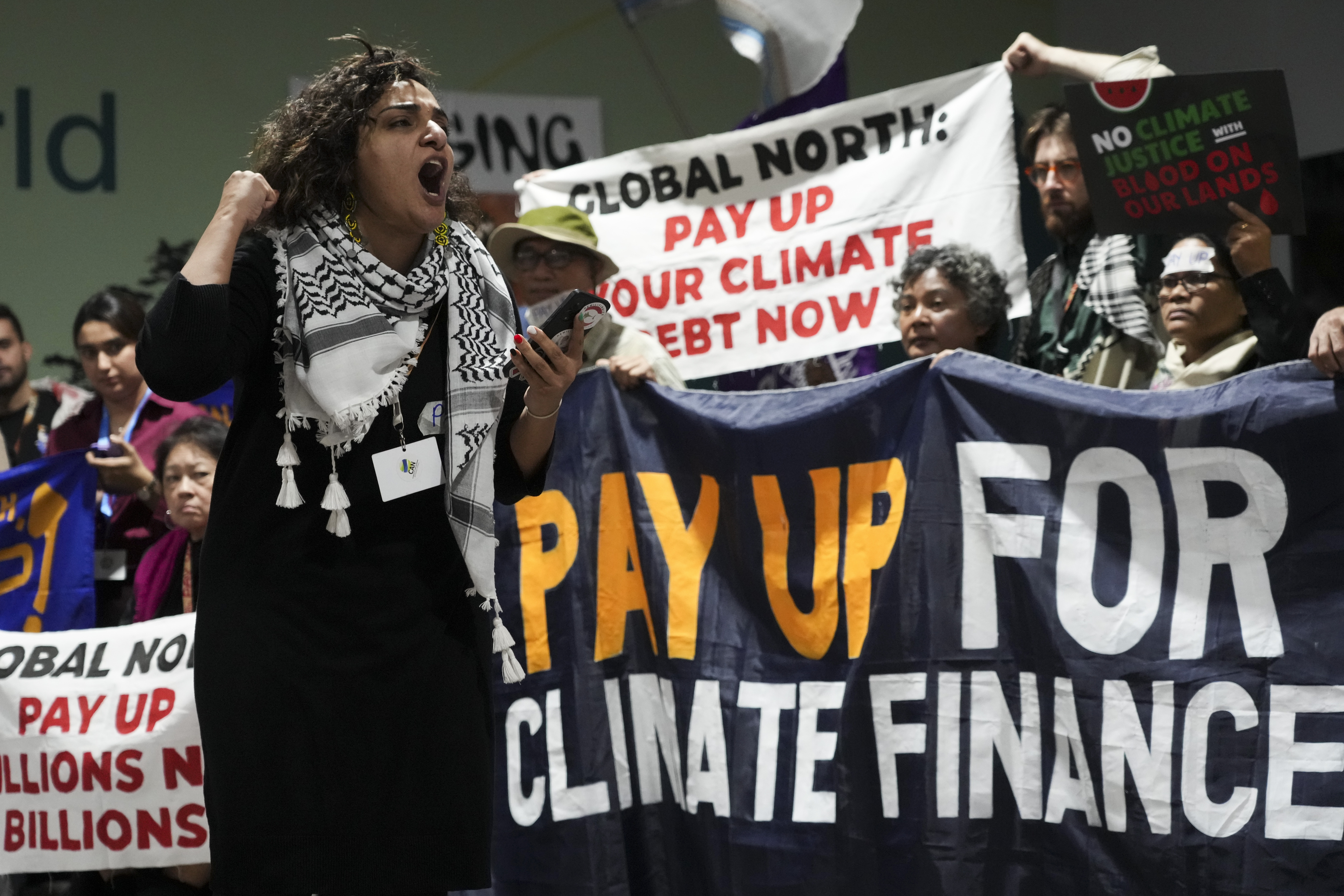 Activists participate in a demonstration for climate finance at the COP29 U.N. Climate Summit, Friday, Nov. 22, 2024, in Baku, Azerbaijan. (AP Photo/Sergei Grits)