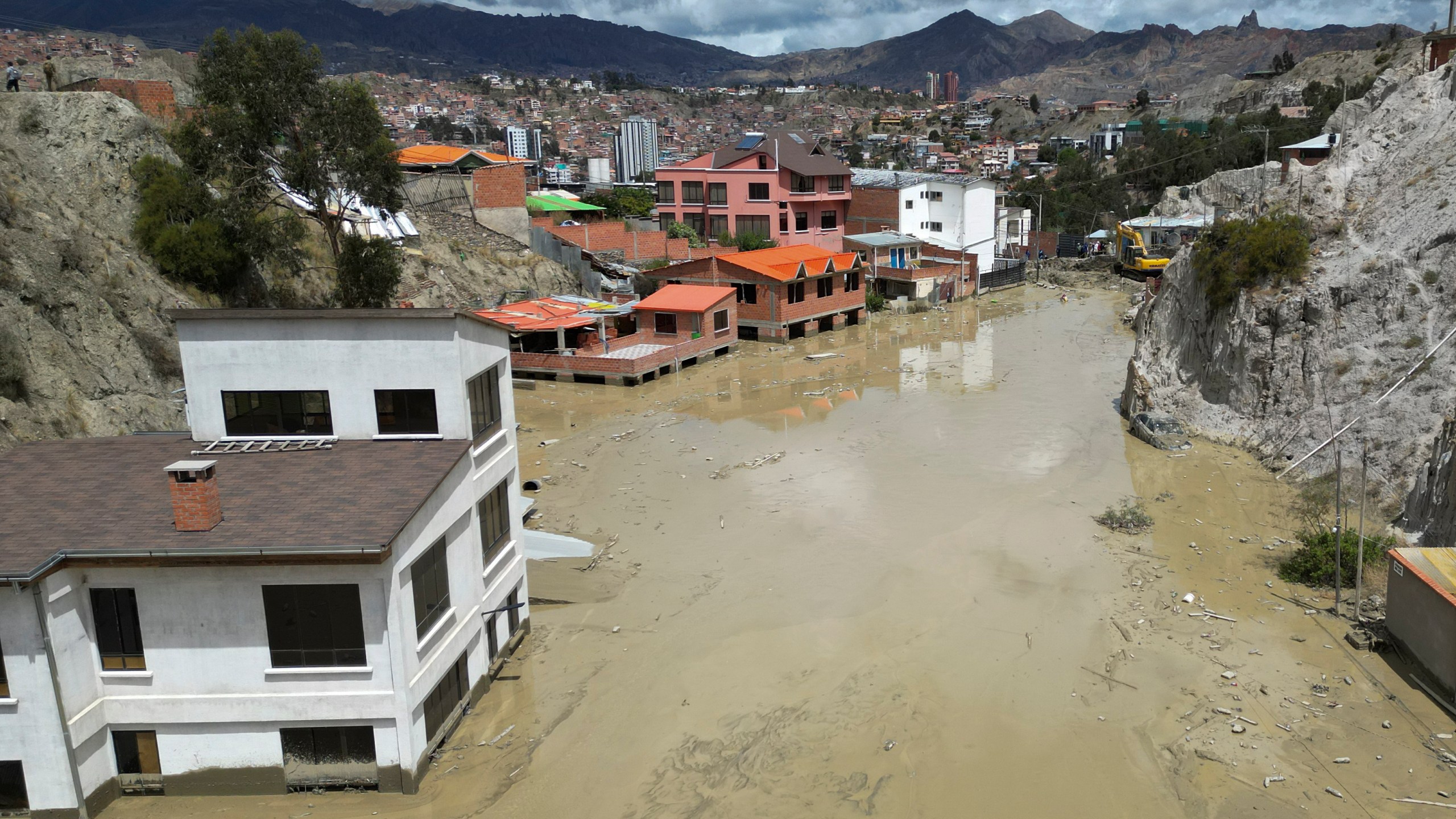 Homes are flooded by the overflowing Pasajahuira River in La Paz, Bolivia, Sunday, Nov. 24, 2024. (AP Photo/Juan Karita)