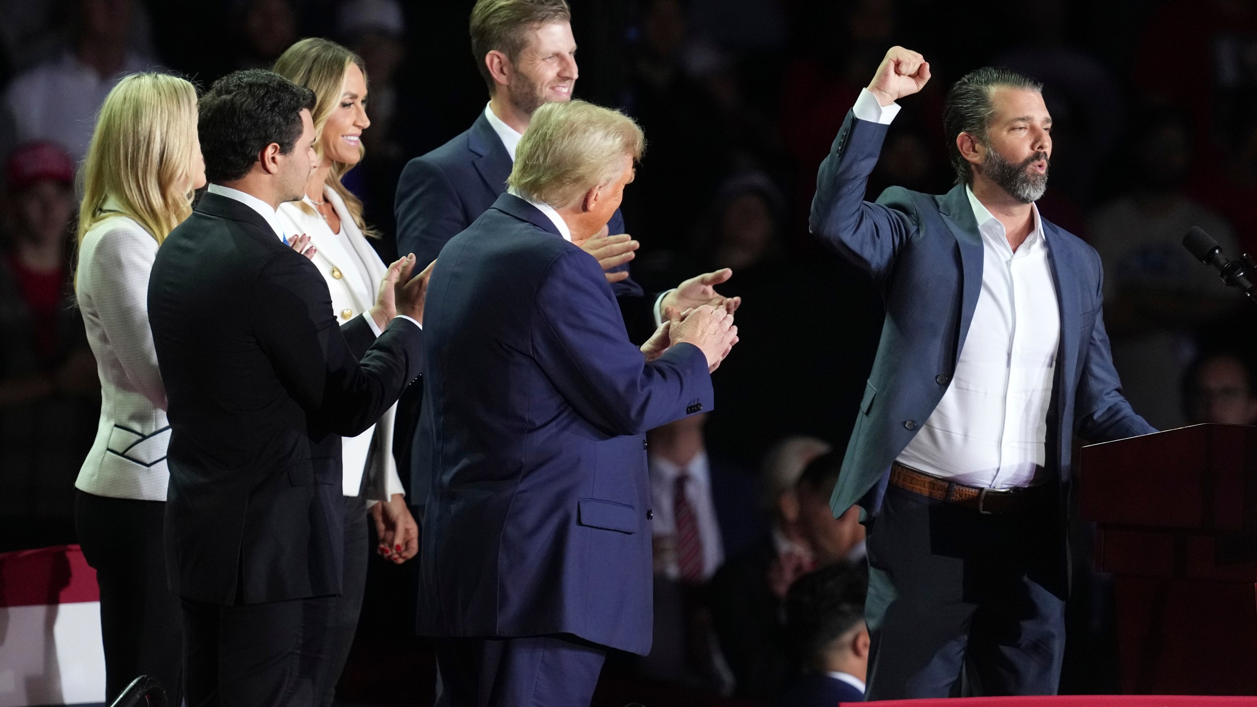 FILE - Michael Boulos and his wife Tiffany Trump, Lara Trump, Eric Trump and Republican presidential nominee former President Donald Trump listen as Donald Trump Jr., speaks at a campaign rally at Van Andel Arena, Nov. 5, 2024, in Grand Rapids, Mich. (AP Photo/Paul Sancya, File)