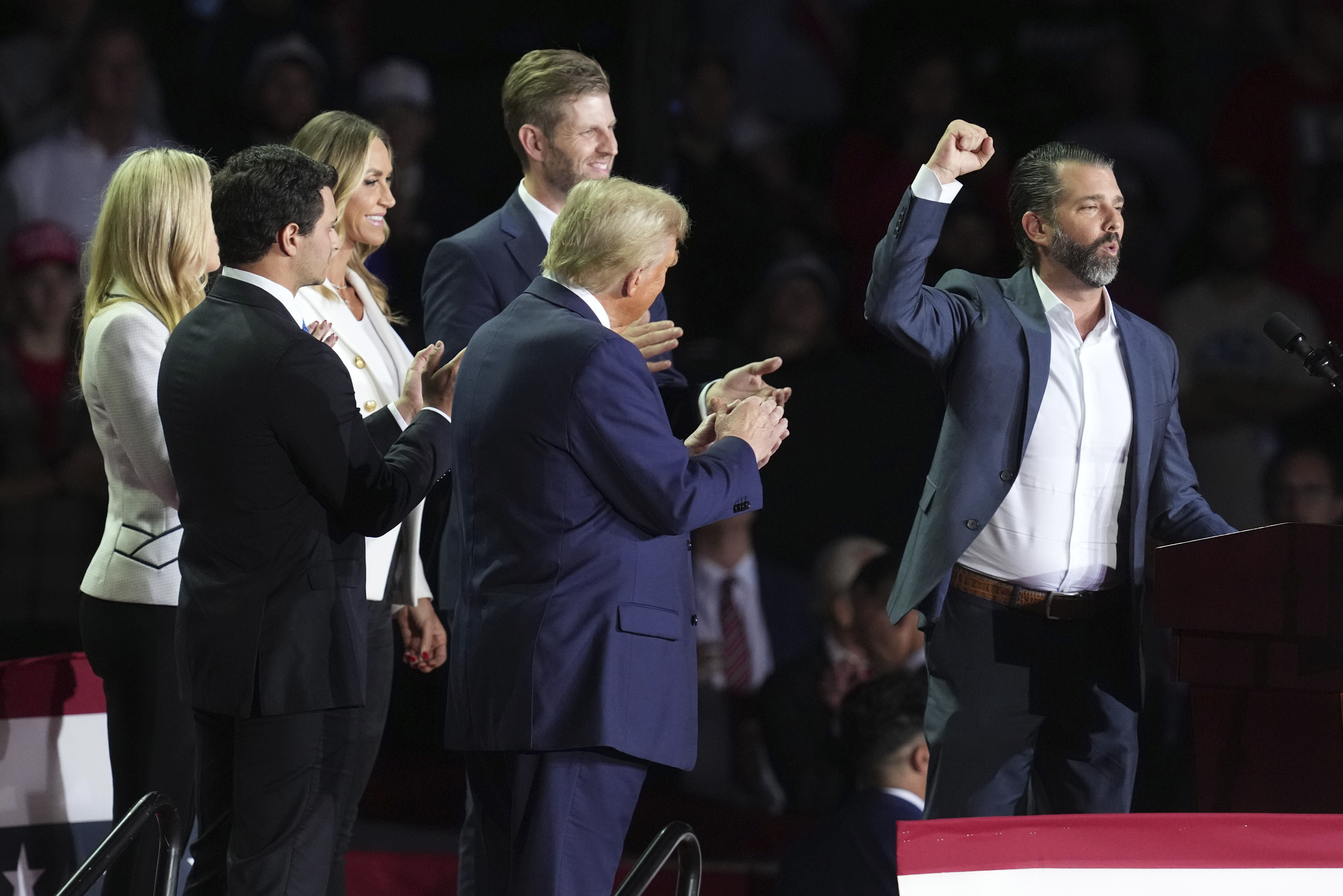 FILE - Michael Boulos and his wife Tiffany Trump, Lara Trump, Eric Trump and Republican presidential nominee former President Donald Trump listen as Donald Trump Jr., speaks at a campaign rally at Van Andel Arena, Nov. 5, 2024, in Grand Rapids, Mich. (AP Photo/Paul Sancya, File)