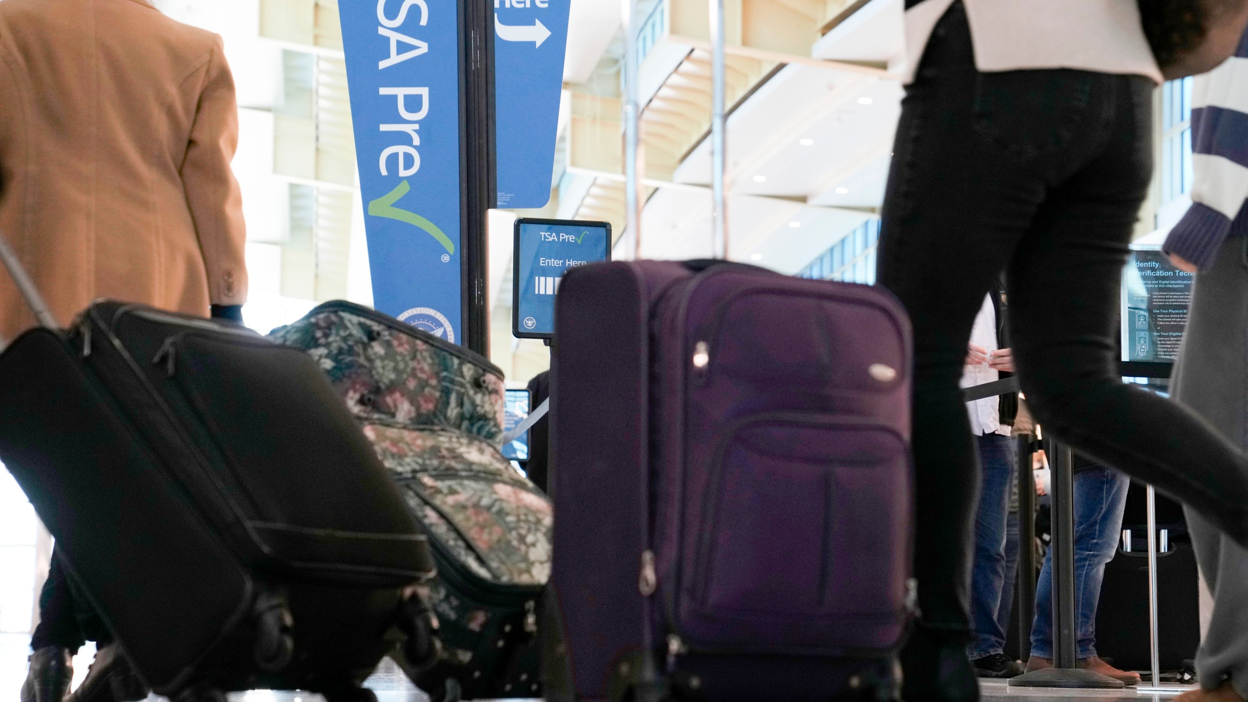 FILE - As the Thanksgiving holiday approaches, travelers walk through Reagan Washington National Airport in Arlington, Va., on Nov. 22, 2023. (AP Photo/Susan Walsh, File)