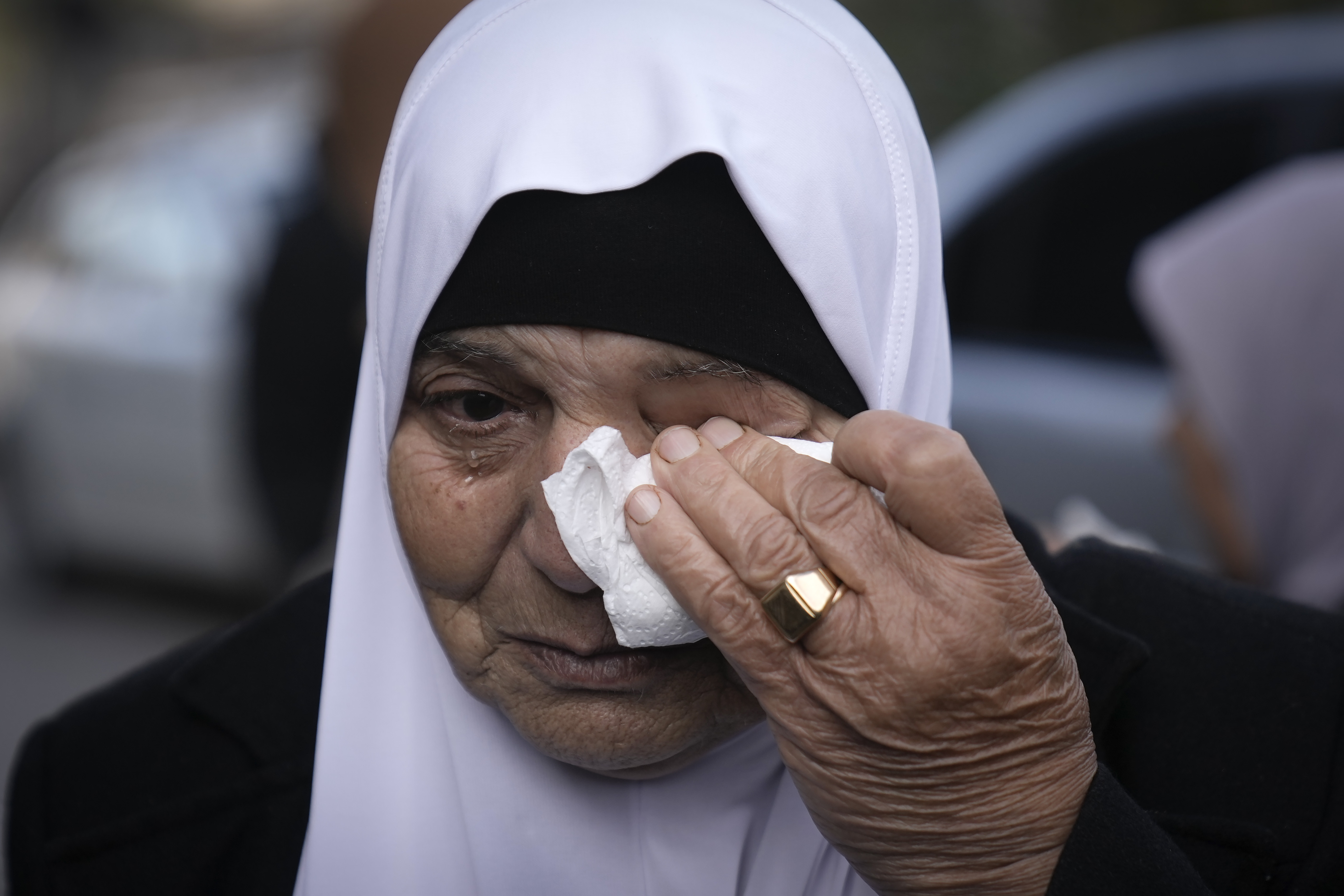 A woman cries as she attends the funeral of Muhammad Hamarsheh, 13, and Ahmad Zaid, 20, killed during an Israeli military raid in the village of Yabad near the West Bank city of Jenin, Monday, Nov. 25, 2024. (AP Photo/Majdi Mohammed)