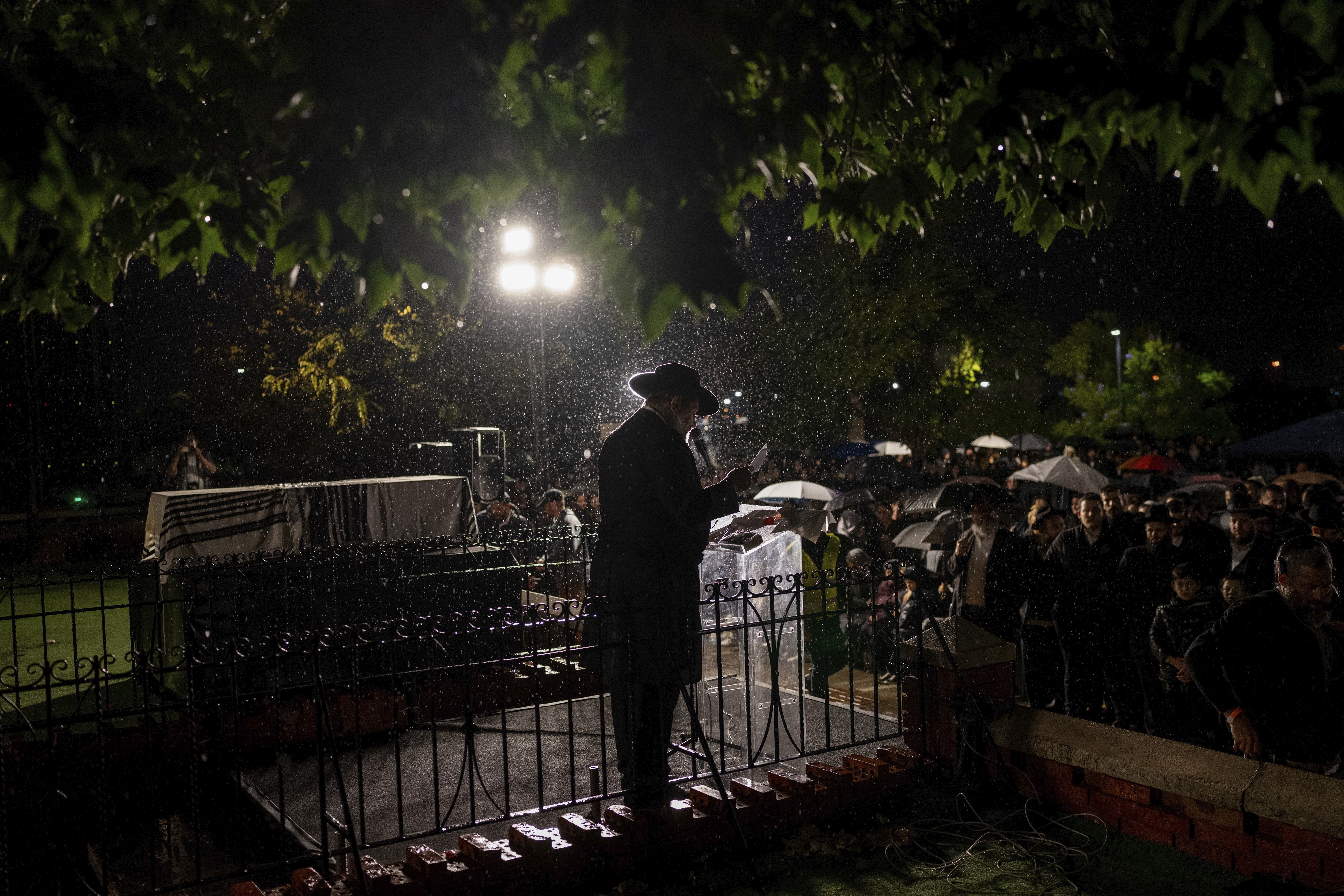 A rabbi delivers an eulogy next to the coffin containing the remains of Israeli-Moldovan rabbi Zvi Kogan in Kfar Chabad, Israel, Monday Nov. 25, 2024. Kogan, 28, an ultra-Orthodox rabbi, was killed last week in Dubai where he ran a kosher grocery store. Israelis have flocked for commerce and tourism since the two countries forged diplomatic ties in the 2020 Abraham Accords.(AP Photo/Ohad Zwigenberg)