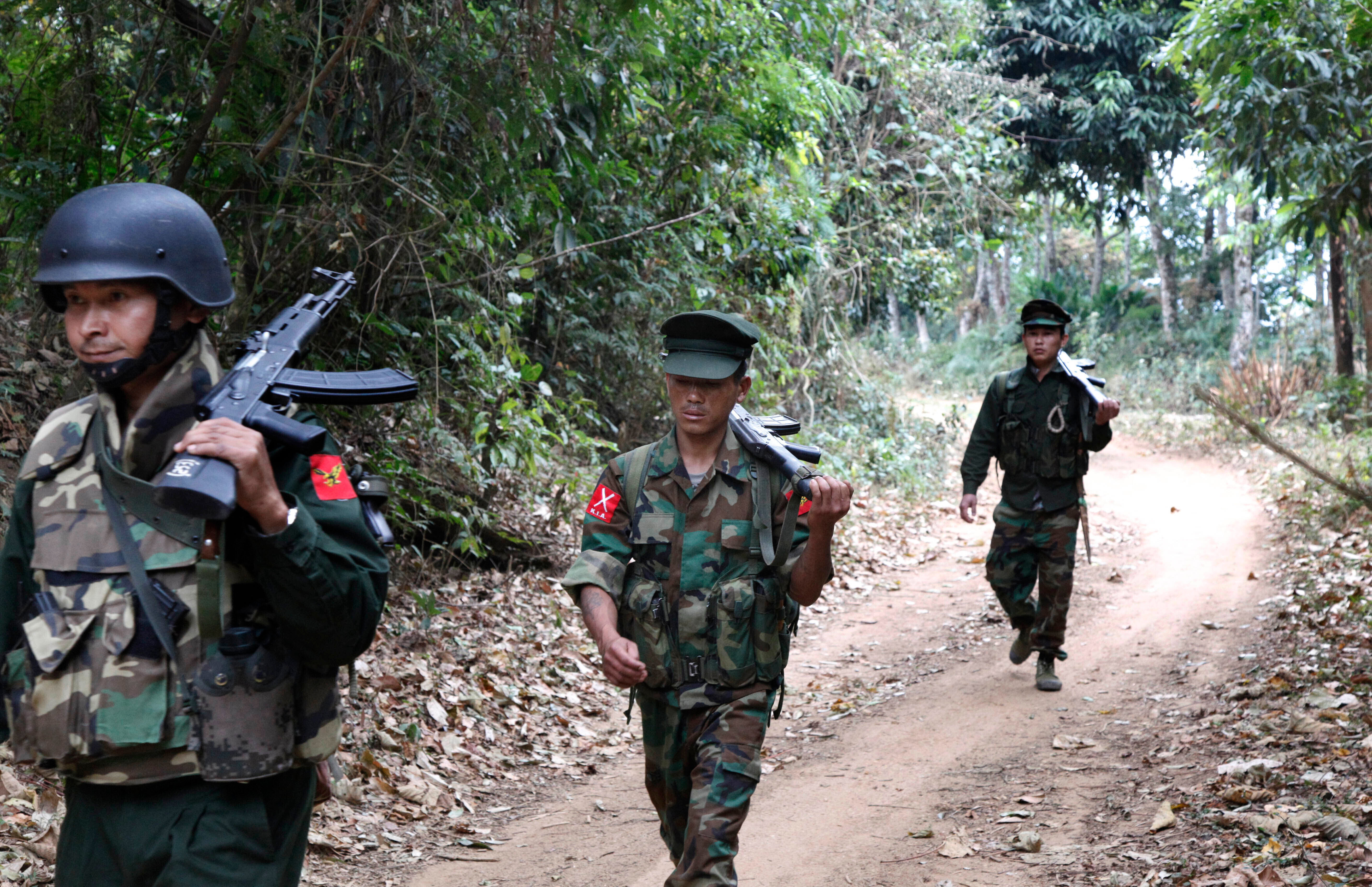 FILE- Kachin Independence Army fighters walk in a jungle path from Mu Du front line to Hpalap outpost in an area controlled by the Kachin rebels in northern Kachin state, Myanmar, March 17, 2018. (AP Photo/Esther Htusan, File)