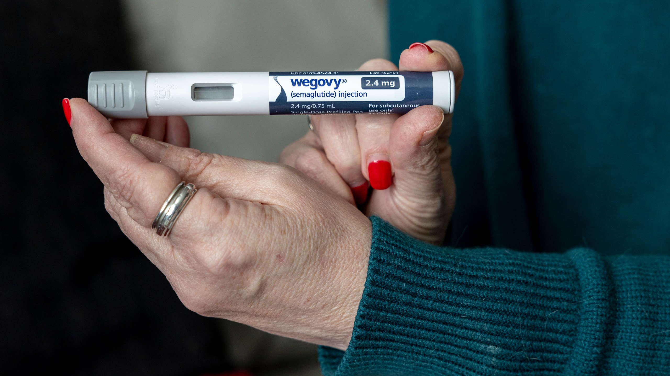 FILE - Donna Cooper holds up a dosage of Wegovy, a drug used for weight loss, at her home, March 1, 2024, in Front Royal, Va. (AP Photo/Amanda Andrade-Rhoades, File)