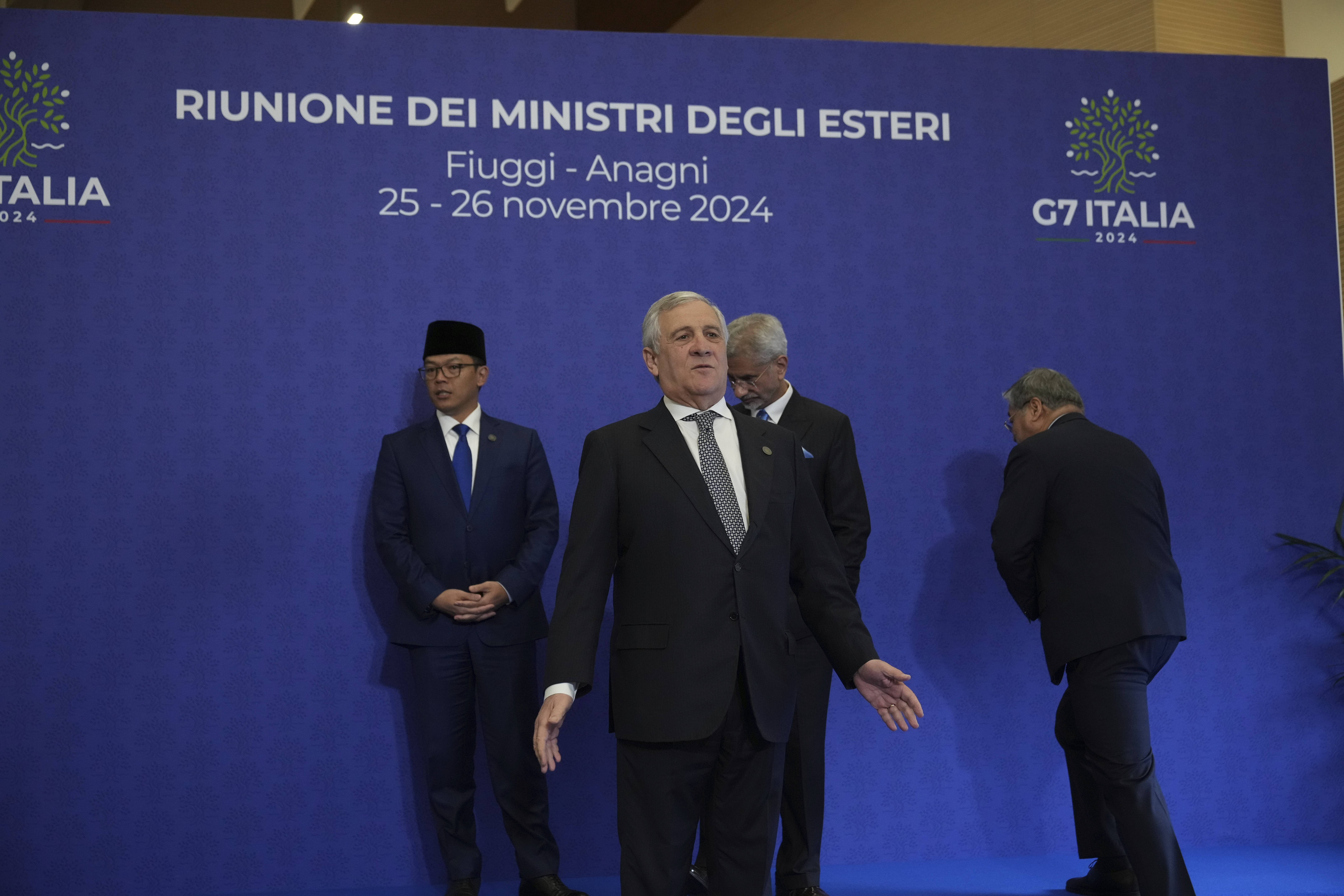 Italian Foreign Minister Antonio Tajani, center, reacts as he waits for the family photo at the G7 of foreign Ministers in Fiuggi, some 70 kilometers south-east of Rome, Tuesday, Nov. 26, 2024. (AP Photo/Alessandra Tarantino, Pool)